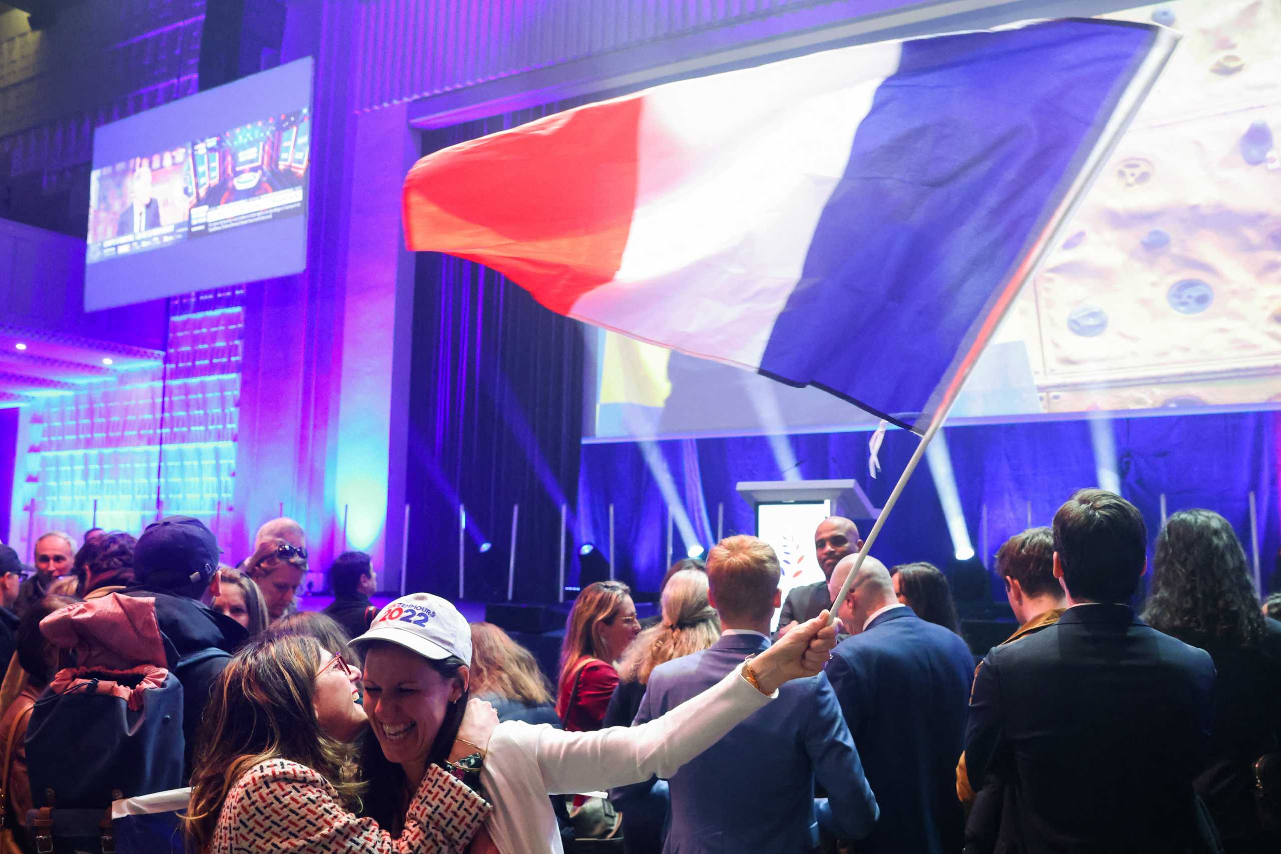 Supporters of the French far-right commentator Eric Zemmour, leader of far-right party "Reconquete!" and candidate for the 2022 French presidential election, react as they wait for partial results in the first round of the 2022 French presidential election, in Paris, France, April 10, 2022. REUTERS