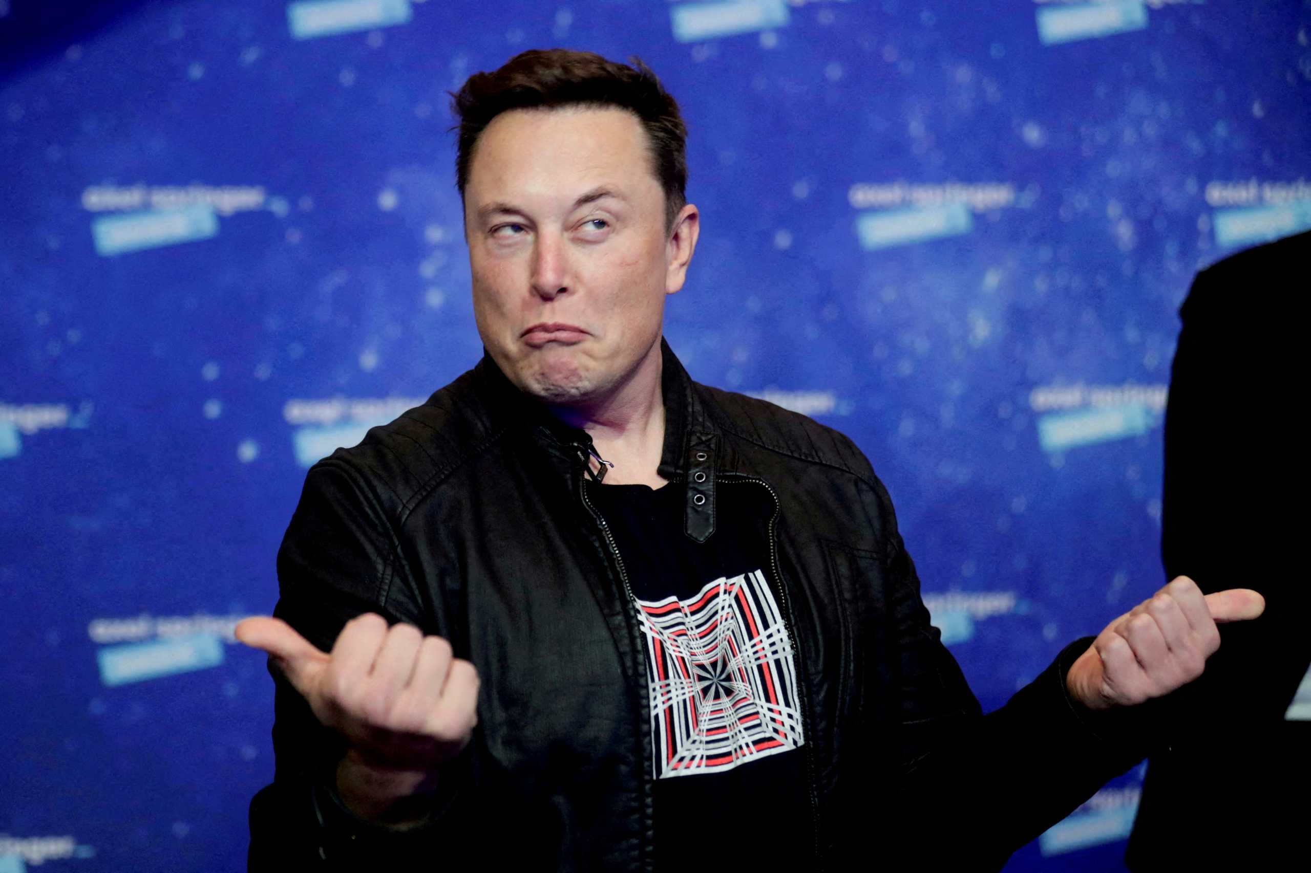 FILE PHOTO: SpaceX owner and Tesla CEO Elon Musk grimaces after arriving on the red carpet for the Axel Springer award in Berlin, Germany, December 1, 2020. REUTERS