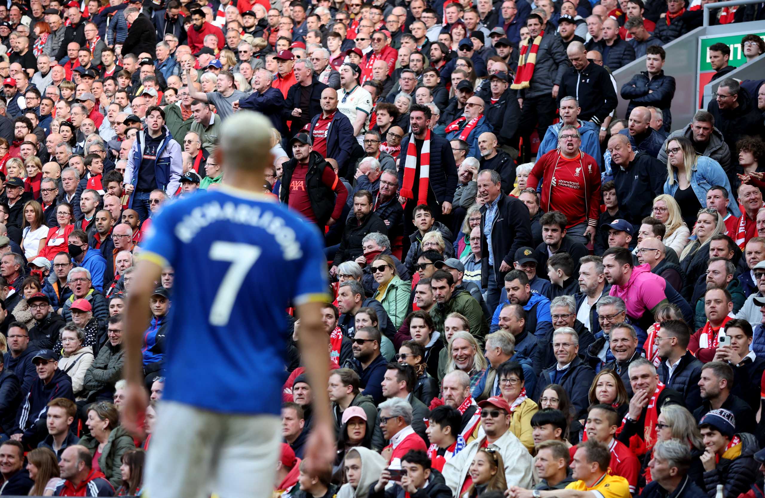 Soccer Football - Premier League - Liverpool v Everton - Anfield, Liverpool, Britain - April 24, 2022  Liverpool fans in the stands as Everton's Richarlison looks on REUTERS