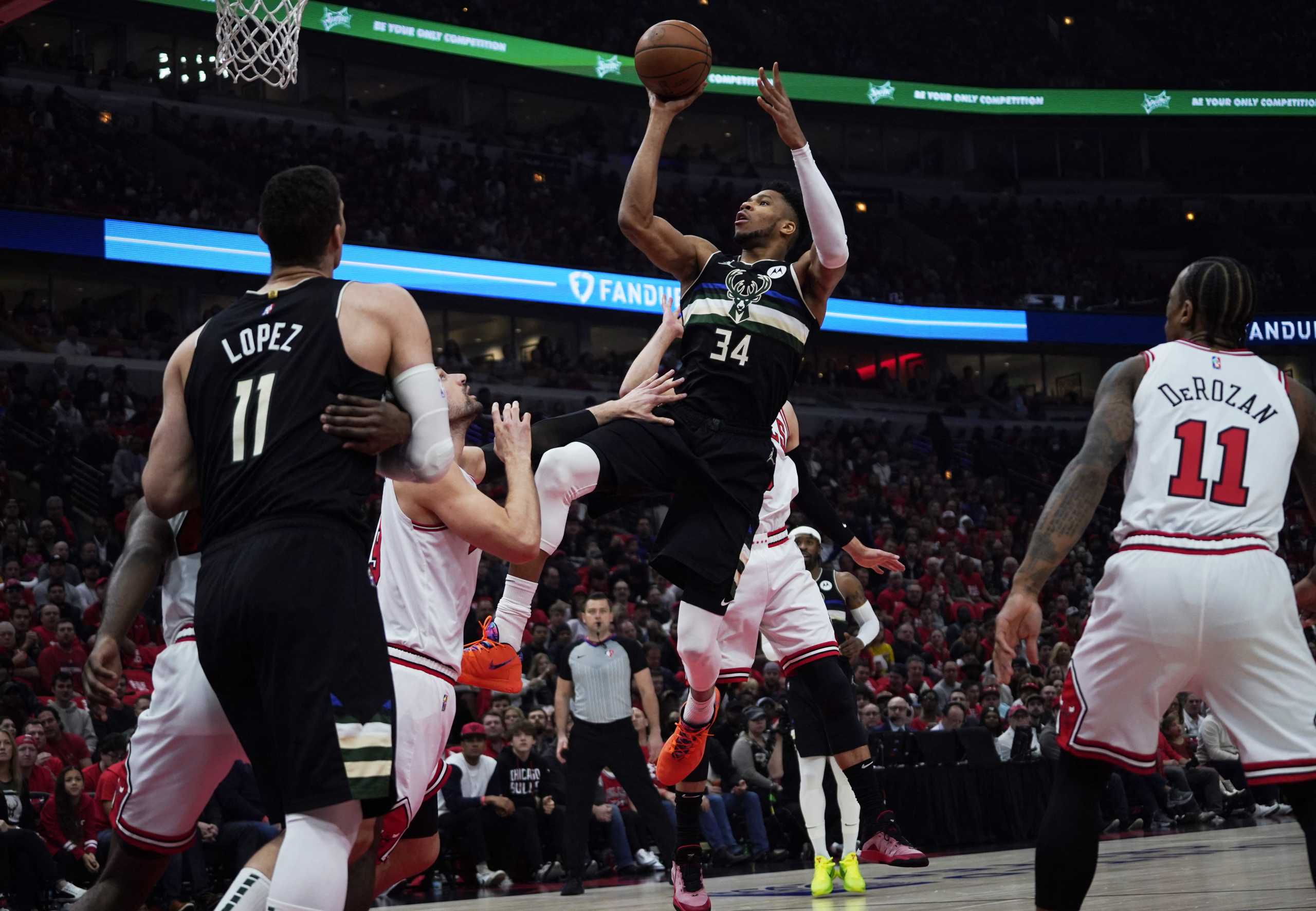 Apr 24, 2022; Chicago, Illinois, USA; Milwaukee Bucks forward Giannis Antetokounmpo (34) shoots over Chicago Bulls center Nikola Vucevic (9) in the first half during game four of the first round for the 2022 NBA playoffs at United Center. Mandatory Credit: David Banks-USA TODAY Sports