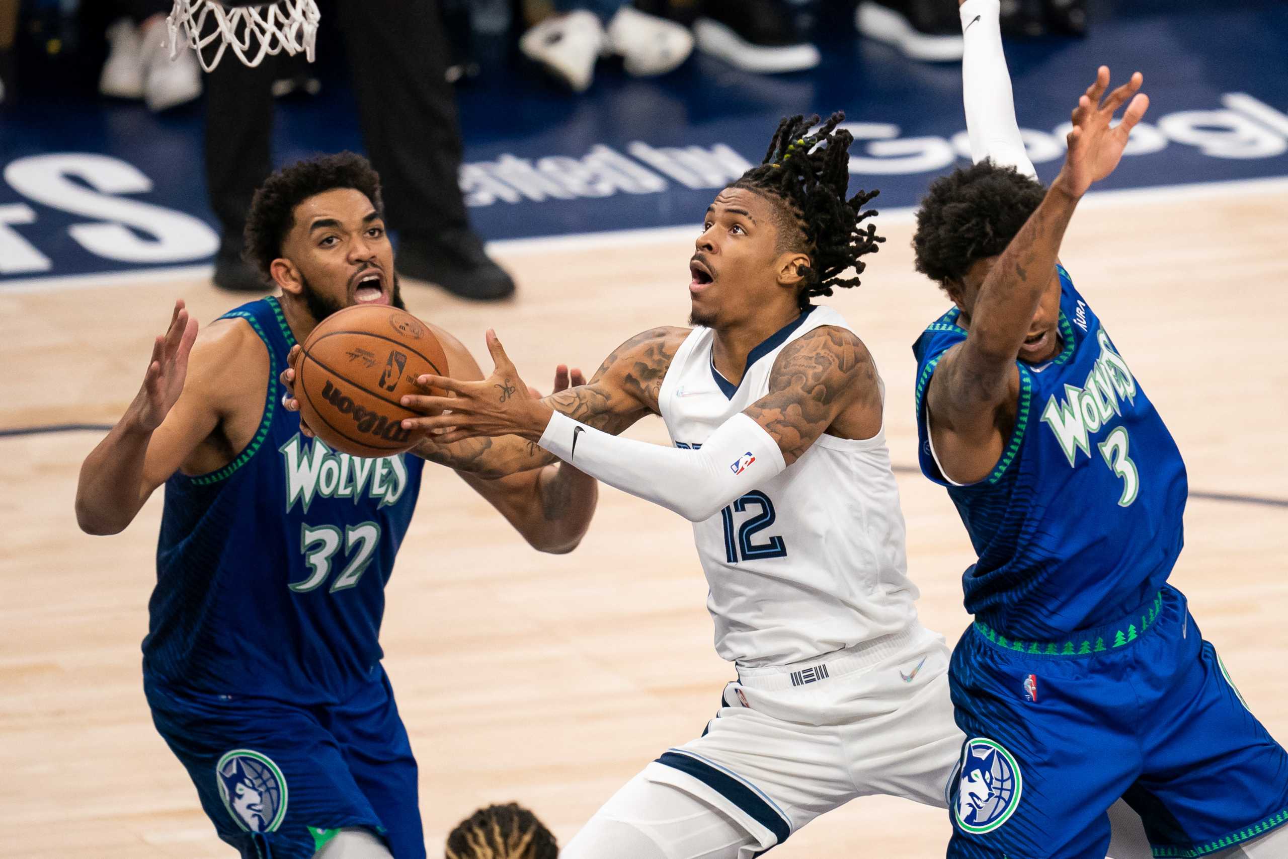 Apr 29, 2022; Minneapolis, Minnesota, USA; Memphis Grizzlies guard Ja Morant (12) shoots against the Minnesota Timberwolves forward Jaden McDaniels (3) in the fourth quarter during game six of the first round for the 2022 NBA playoffs at Target Center. Mandatory Credit: Brad Rempel-USA TODAY Sports