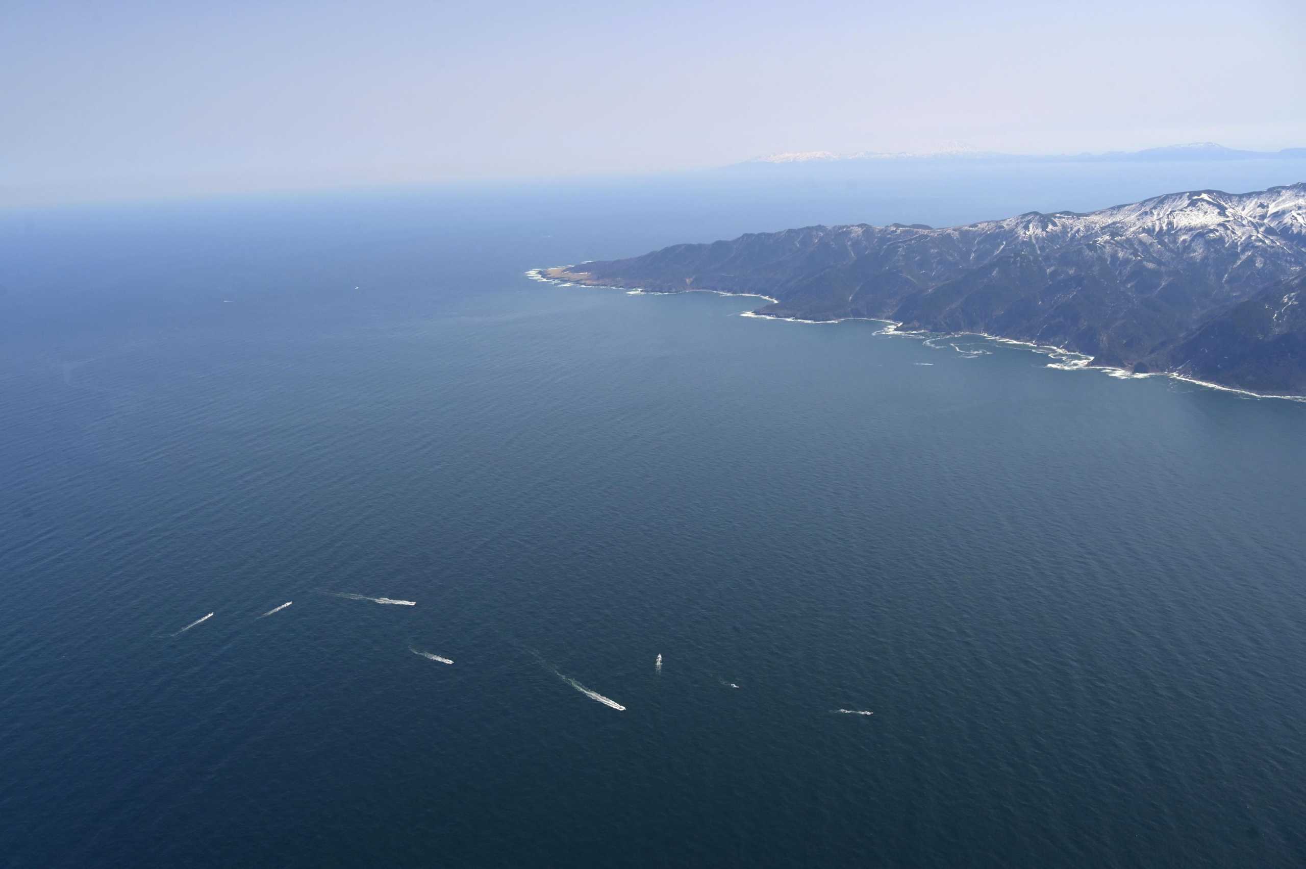 An aerial view shows ships conducting a search operation for people aboard the missing tour boat "Kazu 1" off the Shiretoko Peninsula in Shari, Hokkaido Prefecture, Japan in this photo taken by Kyodo on April 24, 2022. Mandatory credit Kyodo