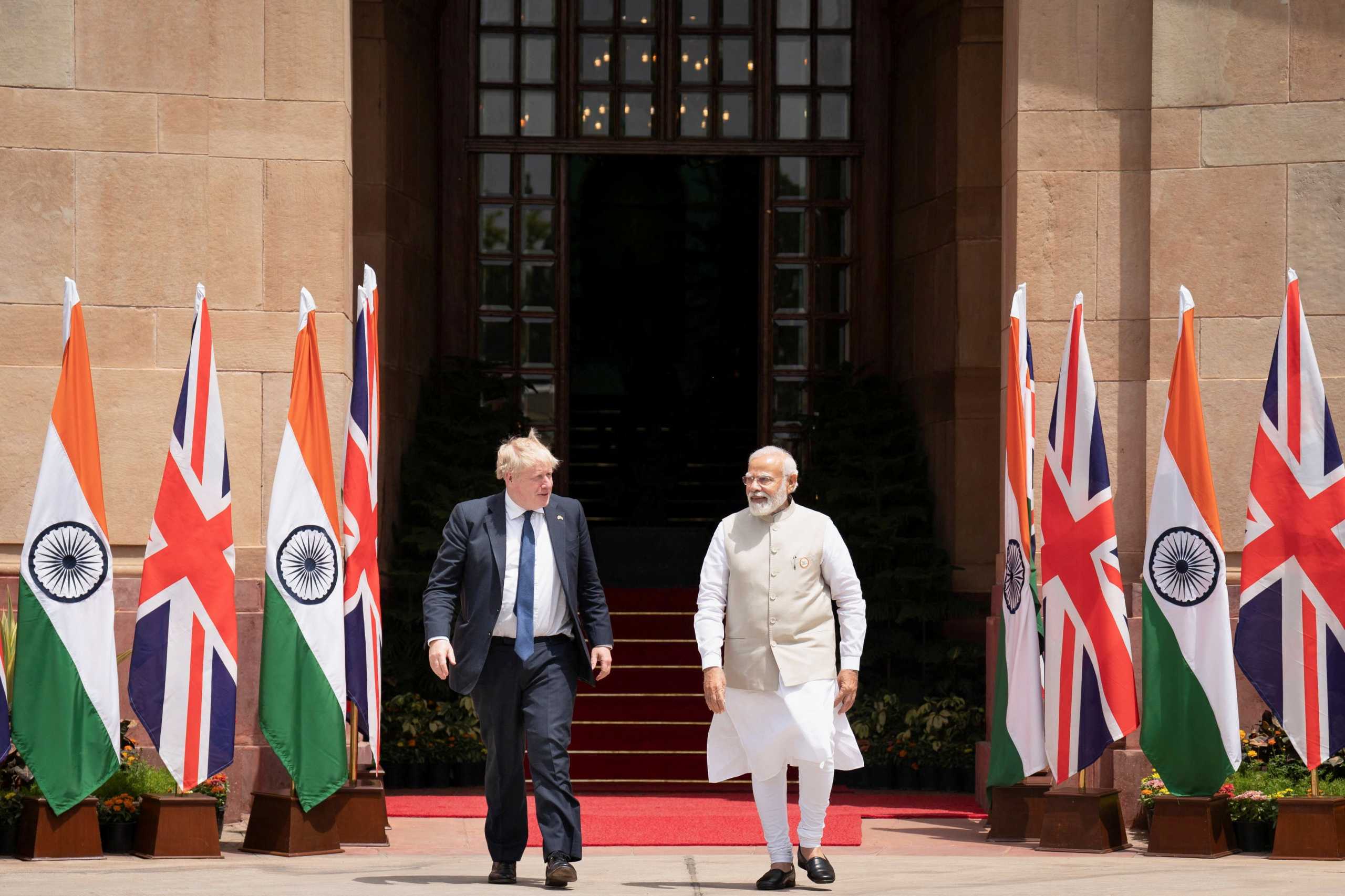 British Prime Minister Boris Johnson and his Indian counterpart Narendra Modi walk before their meeting at the Hyderabad House in New Delhi, India, April 22, 2022. Stefan Rousseau