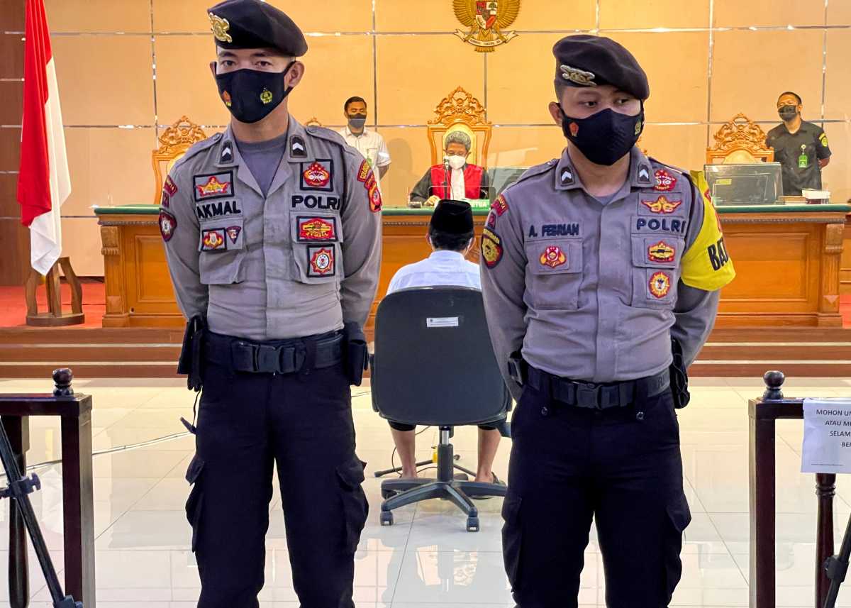 FILE PHOTO: Police officers stand guard during the verdict trial against Herry Wirawan (36), a former teacher and founder of an Islamic boarding school, who is accused of raping 13 school girls between 2016 and 2021, at the district court in Bandung, West Java province, Indonesia February 15, 2022. REUTERS