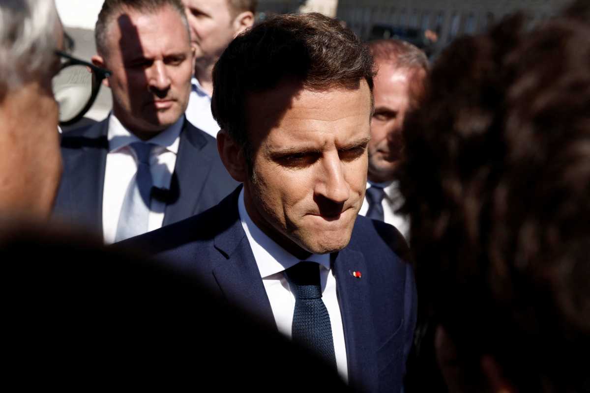 French President Emmanuel Macron, candidate for his re-election in the 2022 French presidential election, reacts as he meets with residents during a campaign trip in Le Havre, France, April 14, 2022.  REUTERS