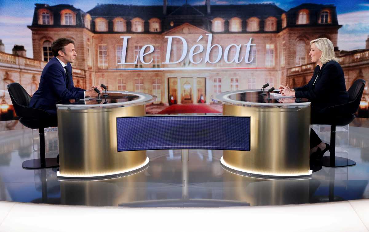 French President Emmanuel Macron, candidate for his re-election, and French far-right Rassemblement National party presidential candidate Marine Le Pen sit prior to taking part in a French presidential election debate, in Saint-Denis, north of Paris, France April 20, 2022. Ludovic Marin