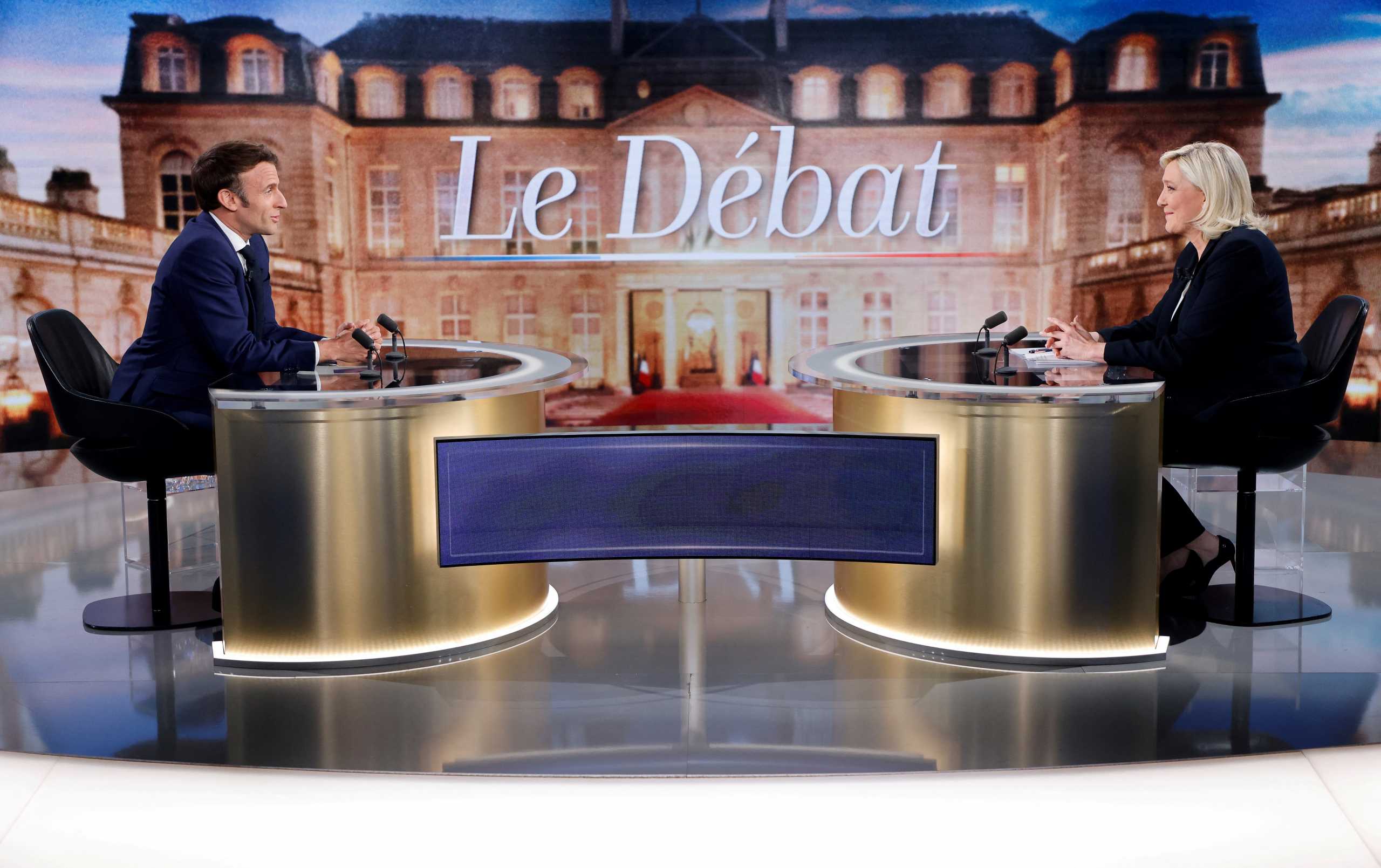 French President Emmanuel Macron, candidate for his re-election, and French far-right Rassemblement National party presidential candidate Marine Le Pen sit prior to taking part in a French presidential election debate, in Saint-Denis, north of Paris, France April 20, 2022. Ludovic Marin