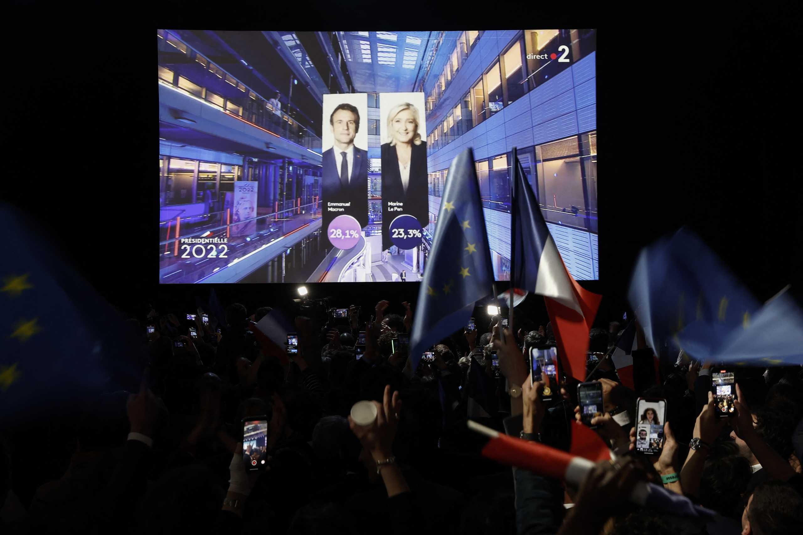 Supporters of French President Emmanuel Macron, candidate for his re-election, react after early results in the first round of the 2022 French presidential election, in Paris, France April 10, 2022.