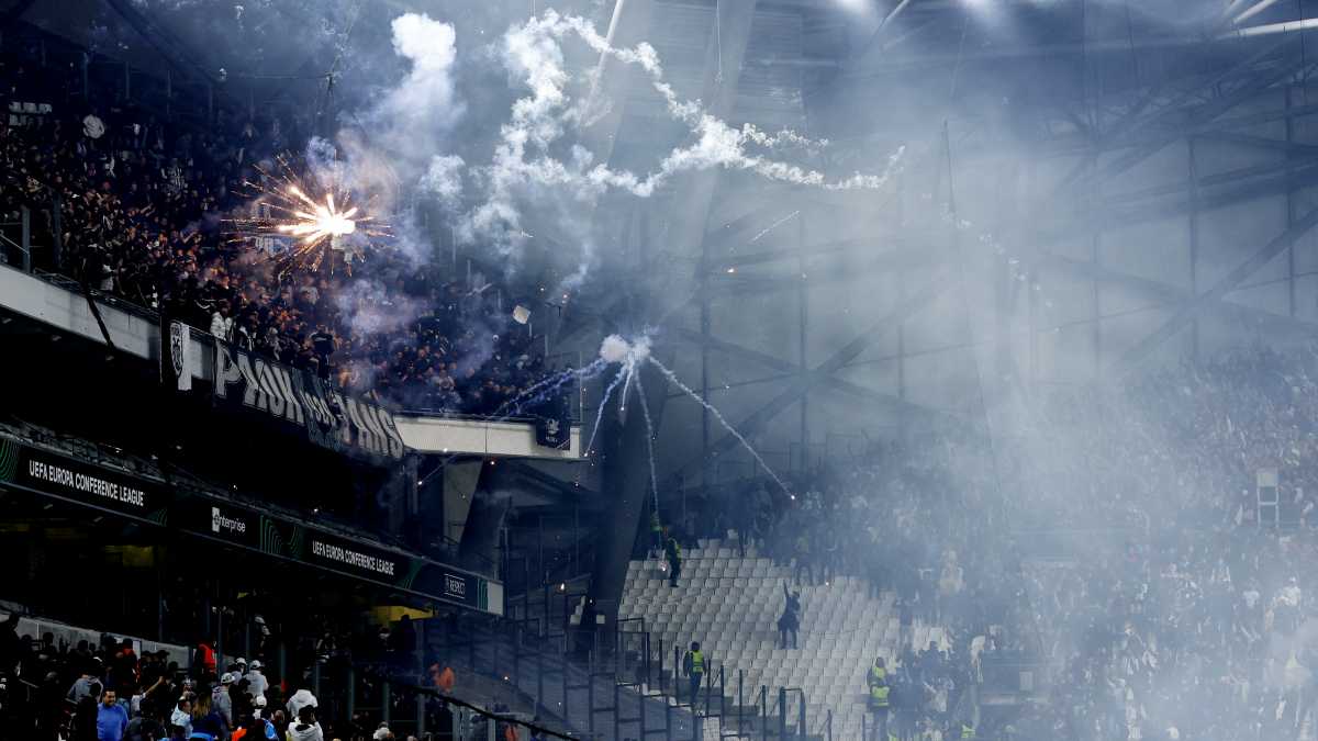 Soccer Football - Europa Conference League - Quarter Final - First Leg - Olympique Marseille v PAOK - Orange Velodrome, Marseille, France - April 7, 2022 Olympique Marseille fans throw flares at PAOK fans inside the stadium before the match REUTERS