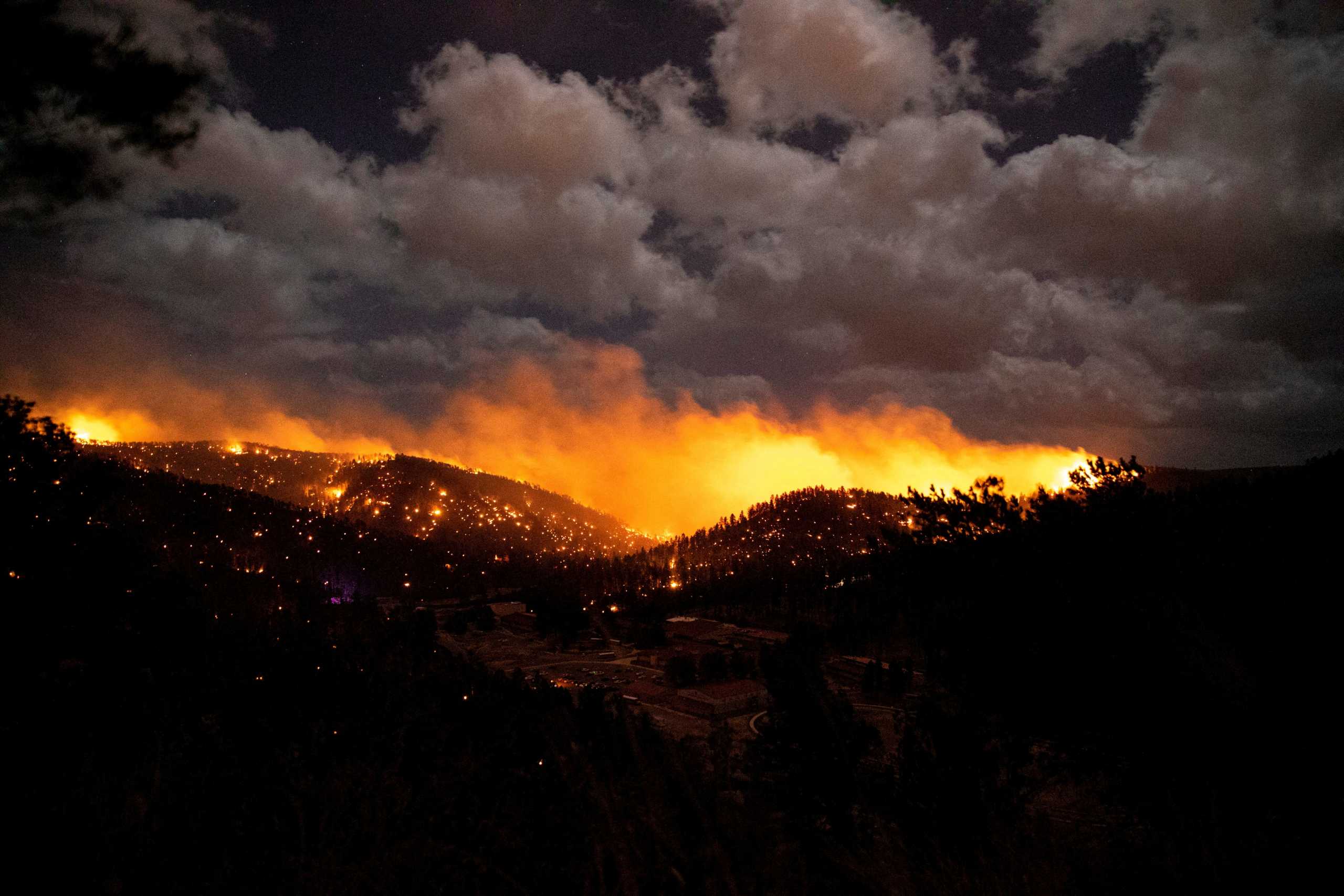 FILE PHOTO: The McBride Fire burns in the heart of the village in Ruidoso, New Mexico, United States, April 12, 2022. Picture taken April 12, 2022.  Ivan Pierre Aguirre