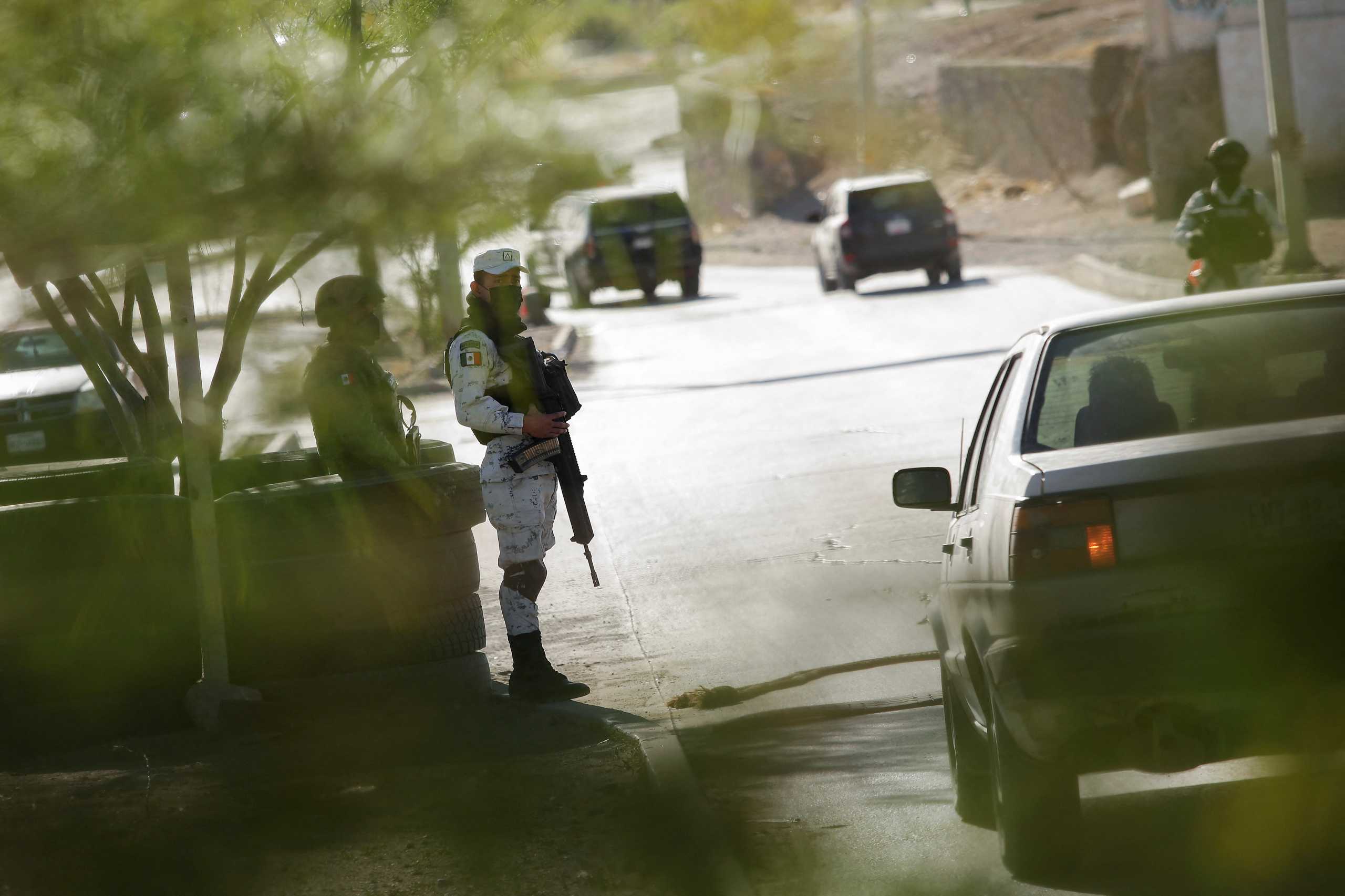 Members of the Mexican National Guard stand guard a military checkpoint, as part of a security operation to reduce violence and the influx of migrants crossing toward the U.S., in Ciudad Juarez, Mexico April 22, 2022. REUTERS