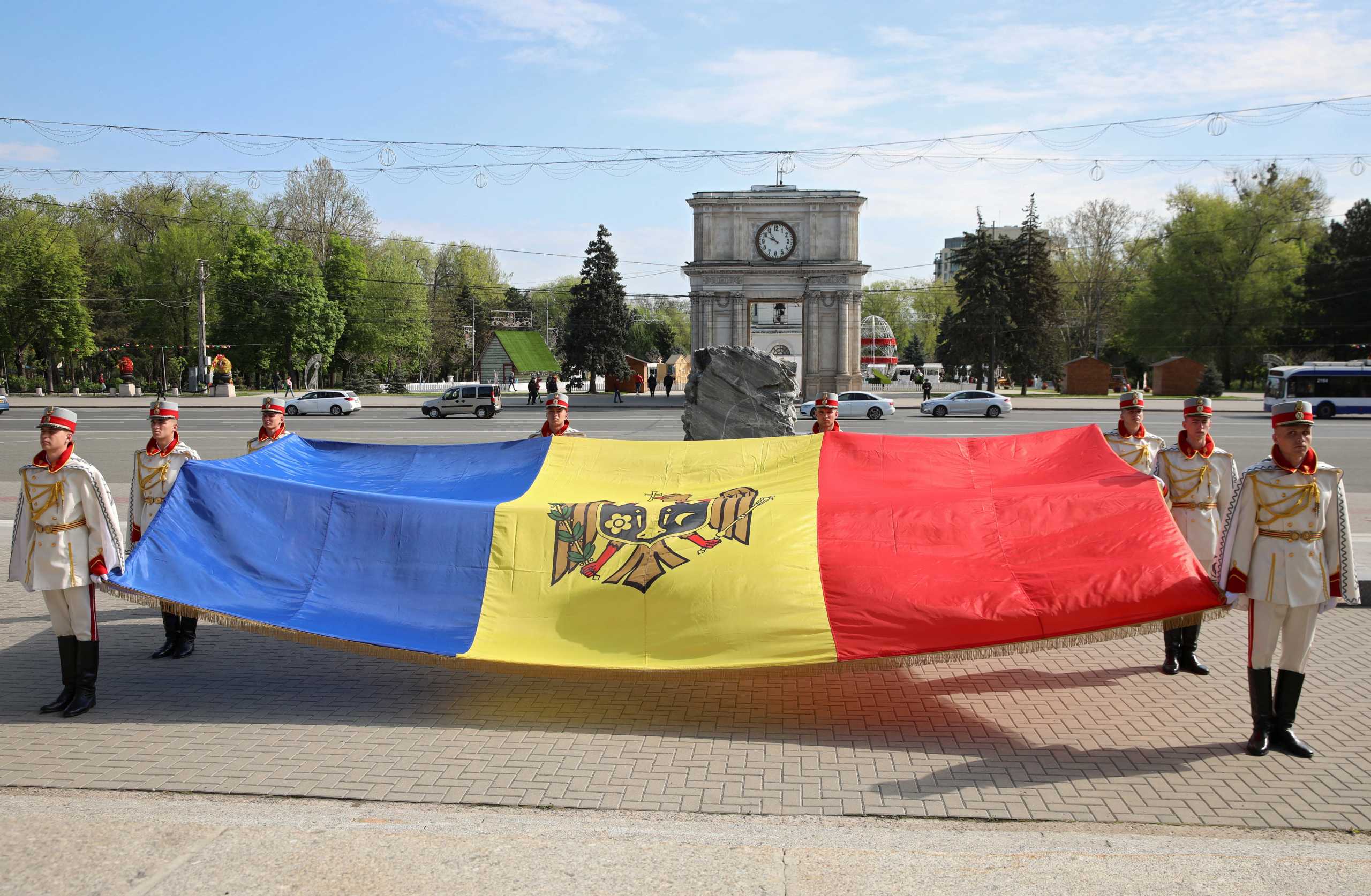 Members of the guard of honor hold the Moldovan flag during a ceremony marking the State Flag Day in Chisinau, Moldova April 27, 2022. REUTERS