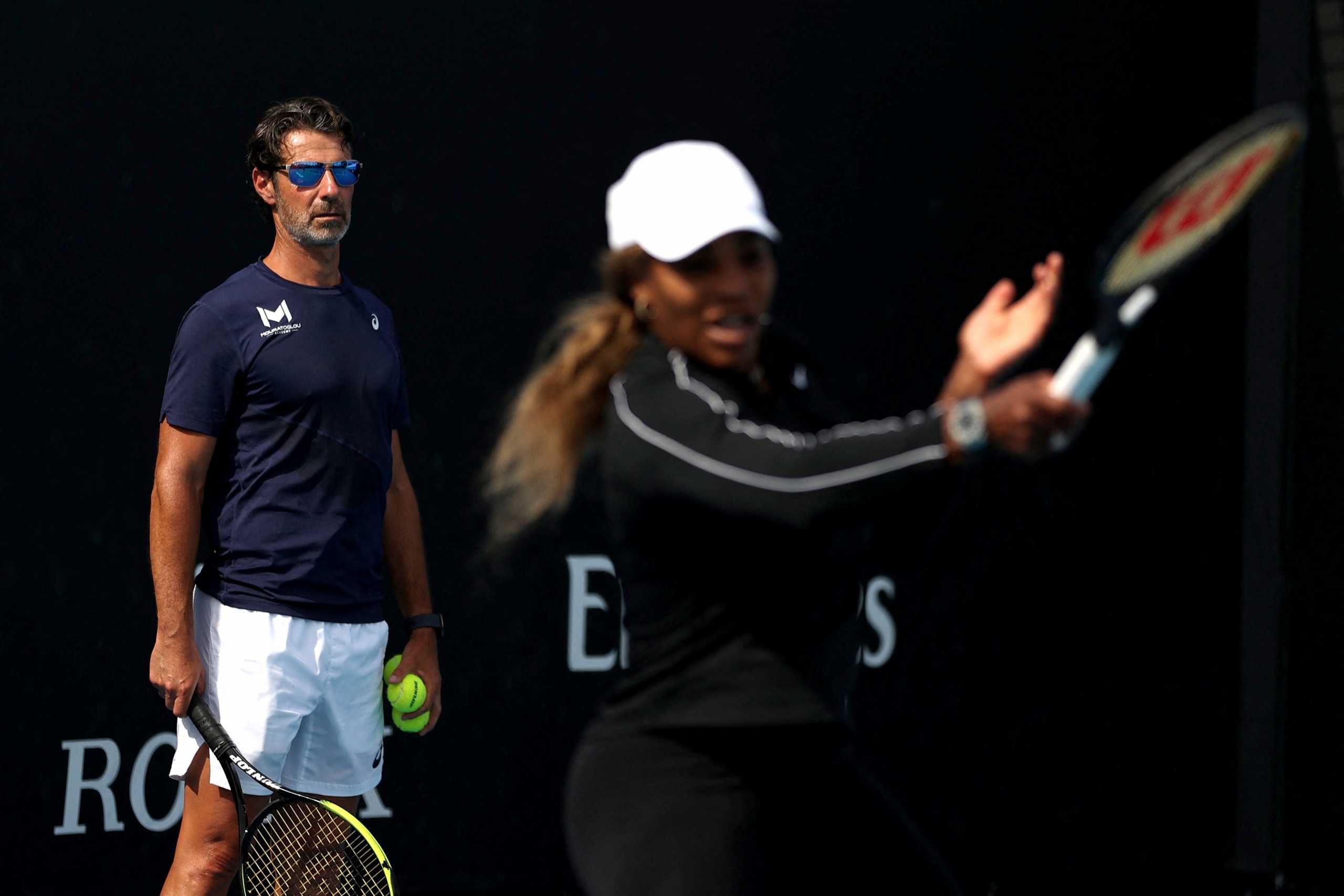FILE PHOTO: Tennis - Australian Open - Melbourne Park, Melbourne, Australia, February 16, 2021 Serena Williams of the U.S. and her coach Patrick Mouratoglou during a practice session REUTERS