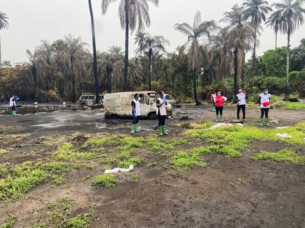 SENSITIVE MATERIAL. THIS IMAGE MAY OFFEND OR DISTURB    Members of the Nigeria Red Cross stand at the scene of explosion in which over 100 people lost their lives, at an illegal crude oil bunkering site at Abaezi forest, in Ohaji-Egbema Local Government Area of Imo state, Nigeria April 24, 2022. REUTERS