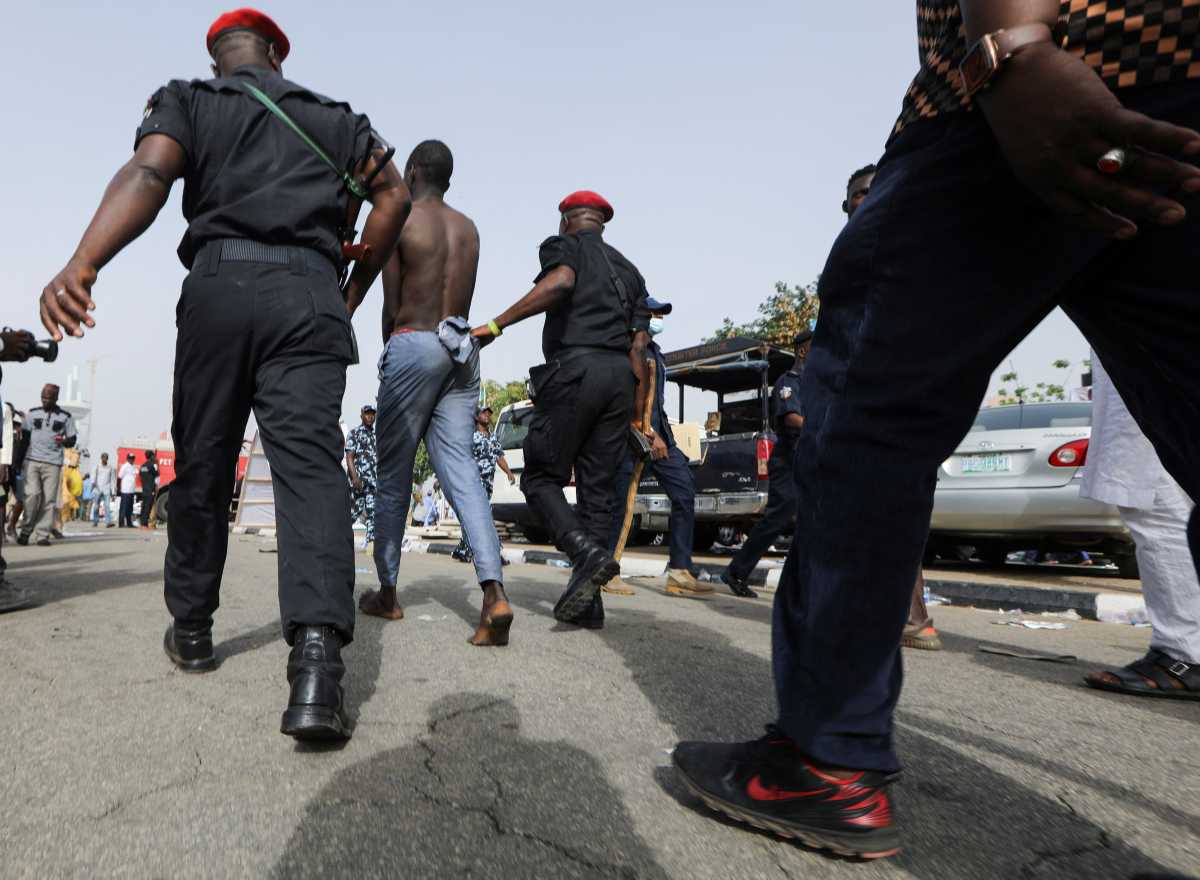 A man is arrested for stealing during the All Progressive Congress party National Convention, in Abuja, Nigeria, March 26, 2022. REUTERS