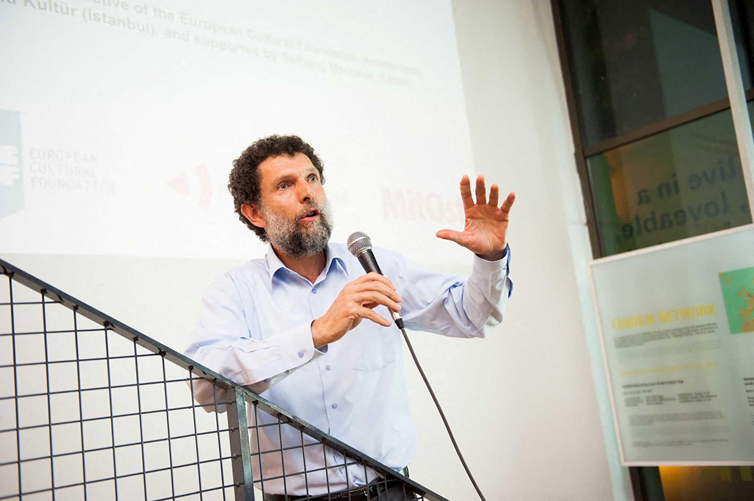 Turkish philanthropist Osman Kavala, accused of attempting to overthrow the government and jailed since late 2017 without a conviction, speaks during an event in this undated handout photo. Anadolu Kultur