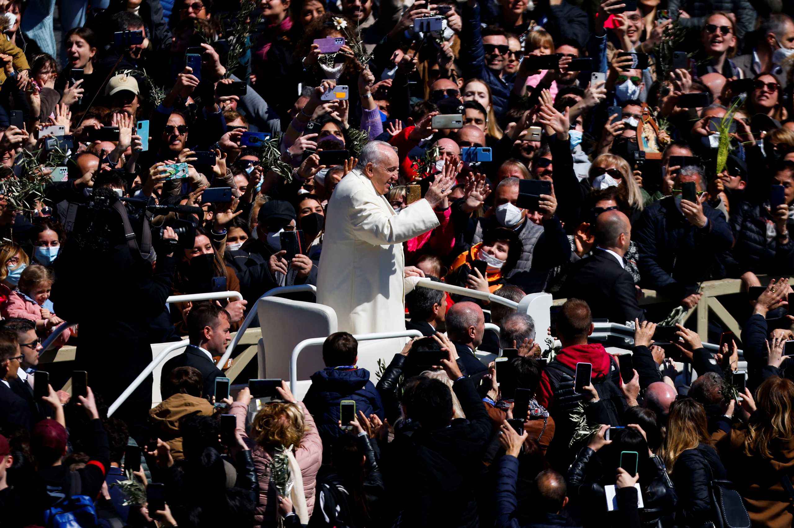 Pope Francis greets people after leading the Palm Sunday Mass at Saint Peter's Square, at the Vatican, April 10, 2022. REUTERS
