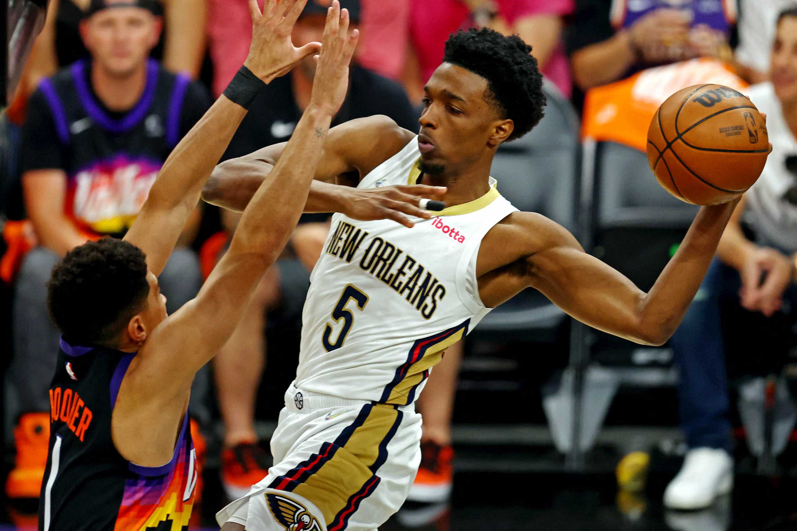 Apr 19, 2022; Phoenix, Arizona, USA; New Orleans Pelicans forward Herbert Jones (5) passes the ball against Phoenix Suns guard Devin Booker (1) during the first quarter during game one of the first round for the 2022 NBA playoffs at Footprint Center. Mandatory Credit: Mark J. Rebilas-USA TODAY Sports