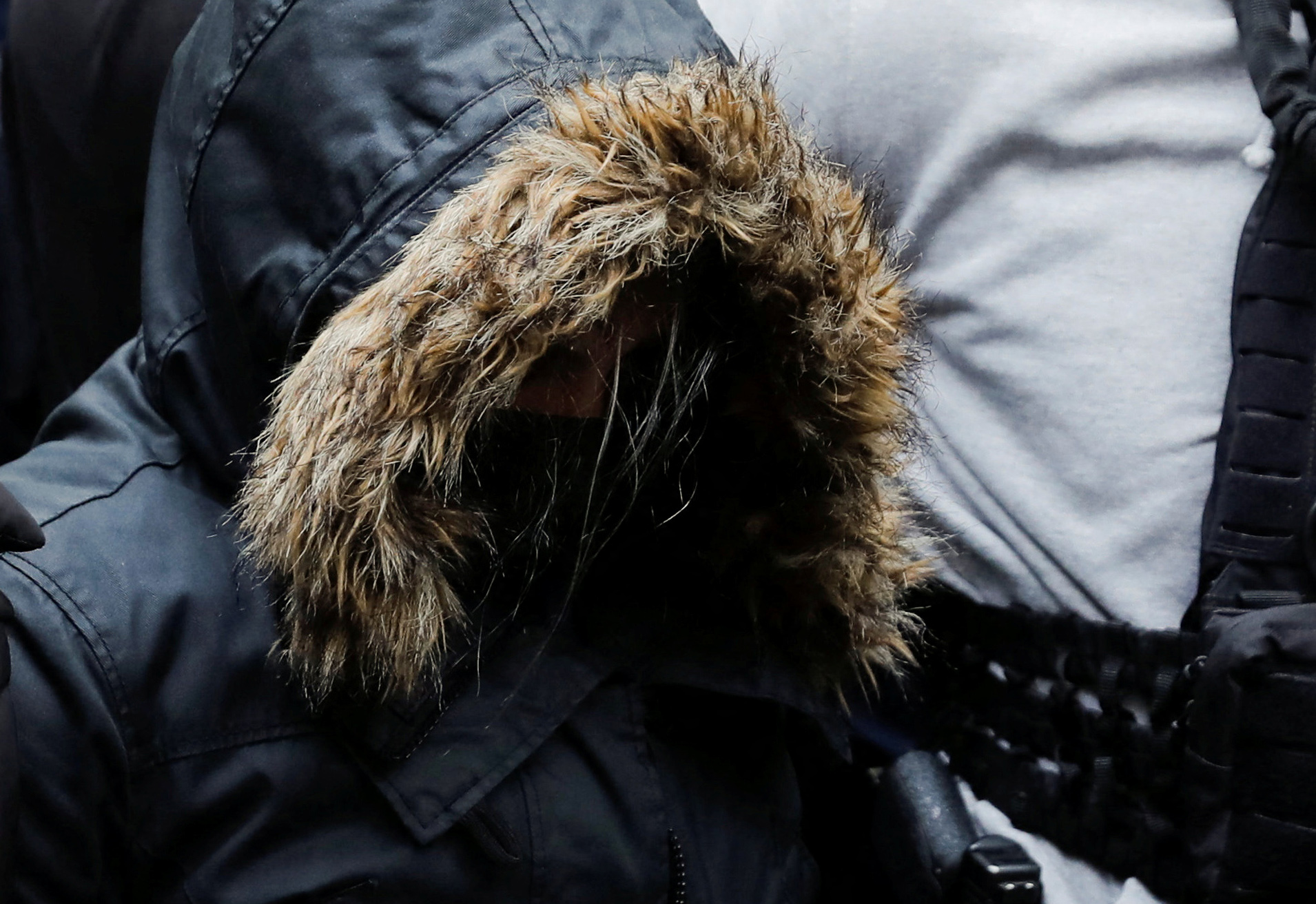 Α 33-years-old Greek woman, who is charged with killing of her 9-year-old daughter, is escorted by police officers to the prosecutors office, in Athens, Greece, March 31, 2022. REUTERS