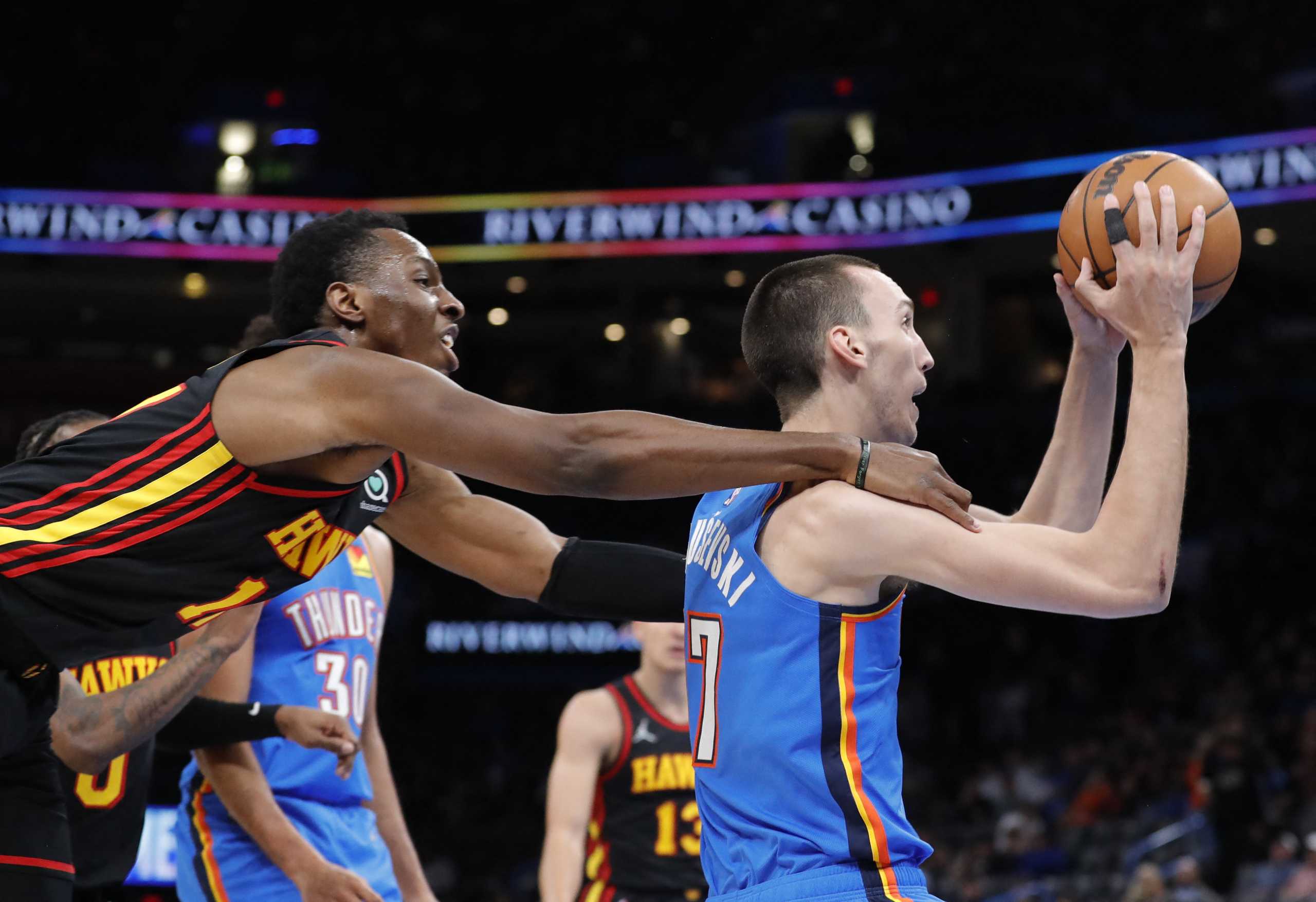 Mar 30, 2022; Oklahoma City, Oklahoma, USA; Atlanta Hawks forward Onyeka Okongwu (left) reaches for Oklahoma City Thunder center Aleksej Pokusevski (right) during the second half at Paycom Center. Mandatory Credit: Alonzo Adams-USA TODAY Sports