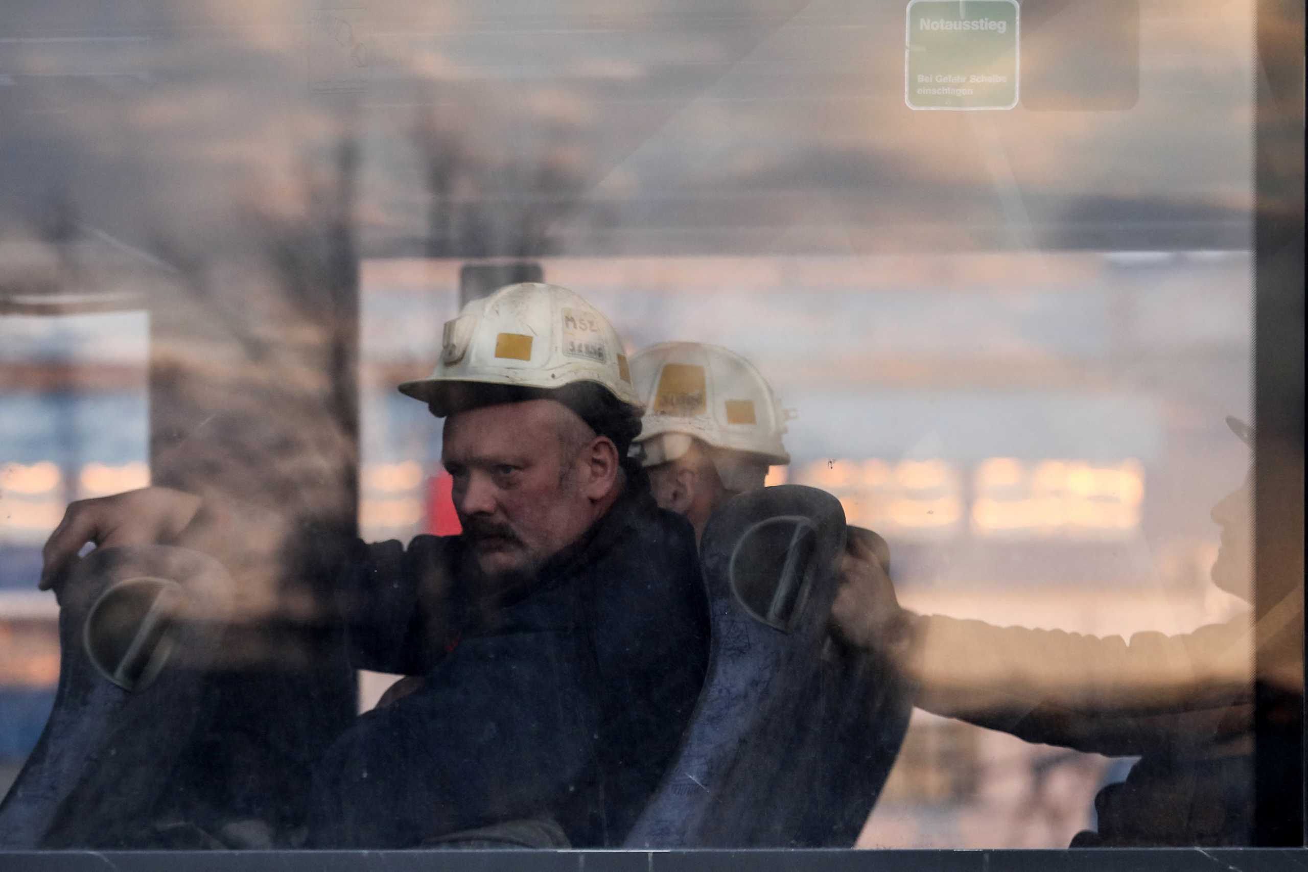 Miners looks from a window as search and rescue operation continues after a tremor at the Borynia-Zofiowka coal mine in Jastrzebie-Zdroj, Poland. April 23, 2022. Picture taken April 23, 2022. Dominik Gajda