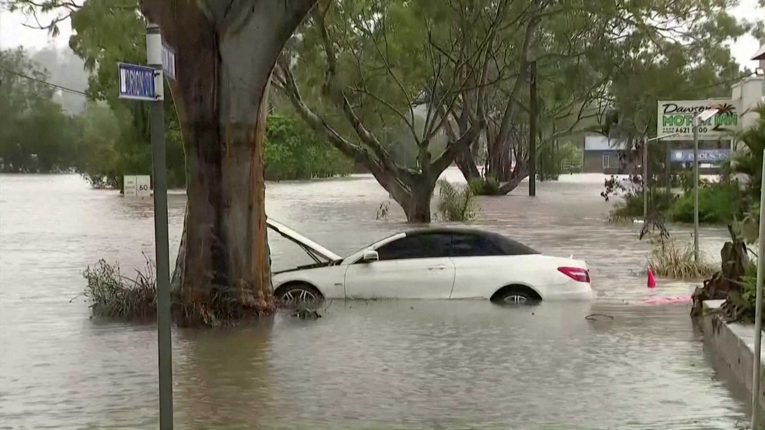 A car is seen submerged in floodwater following heavy rains in the northern town of Lismore, New South Wales, Australia March 30, 2022 in this still image taken from a video. Seven Network