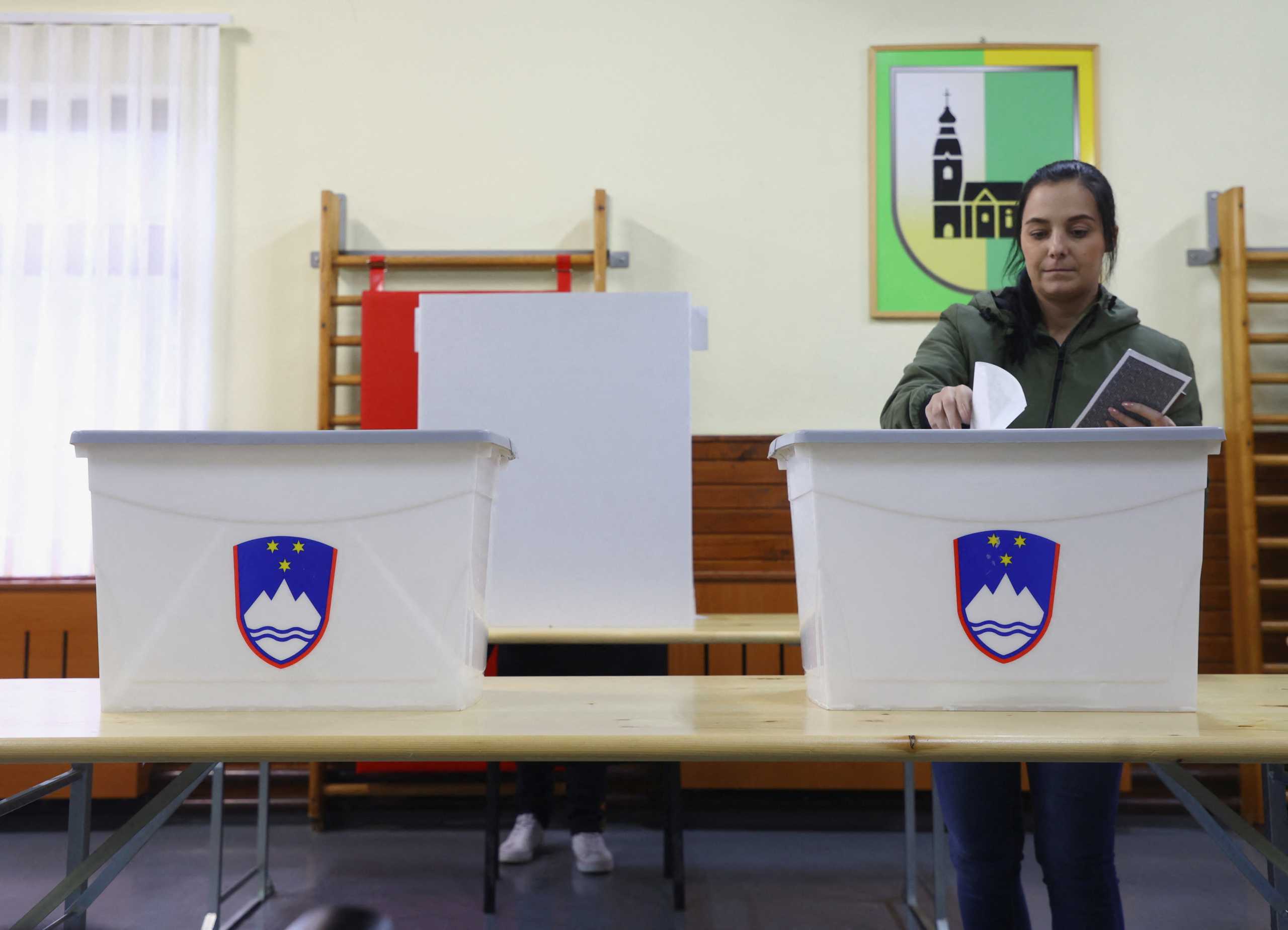 A person votes at a poll for parliamentary elections in Arnace, Slovenia, April 24, 2022. REUTERS