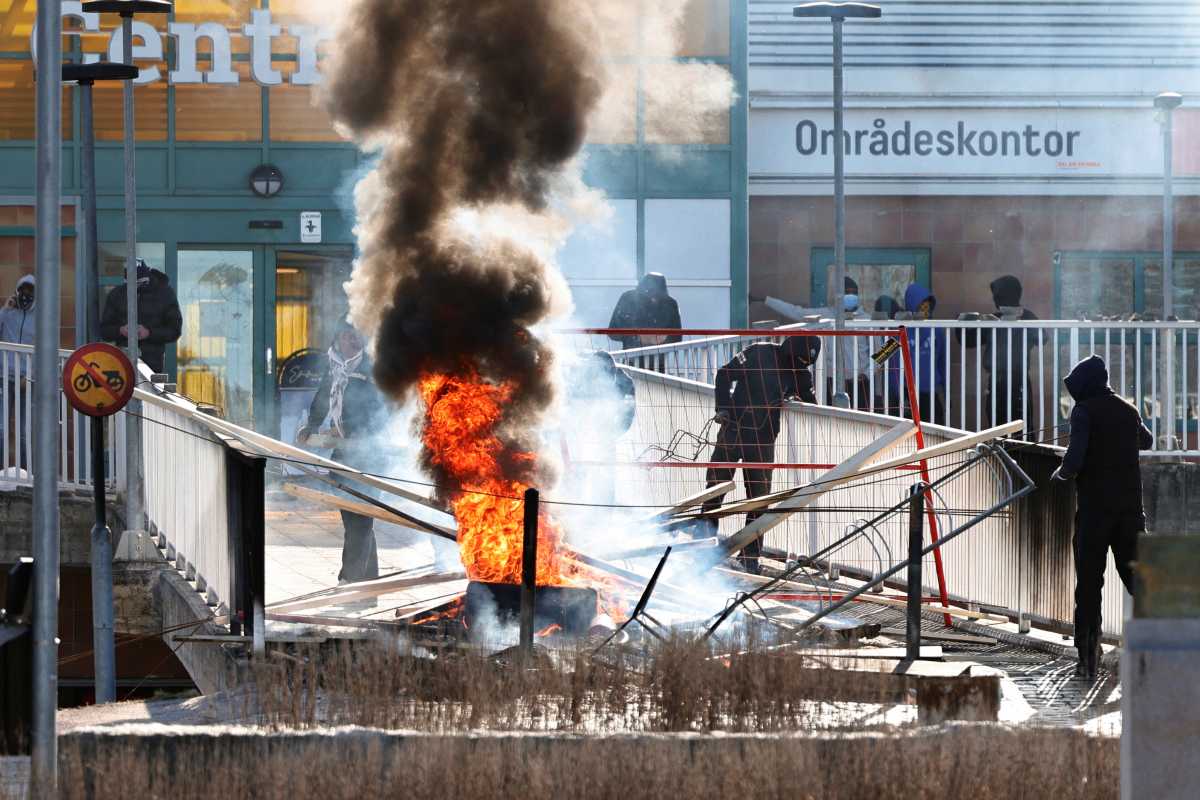 People build a barricade to block an entrance to a shopping area during a riot ahead of a demonstration planned by Danish anti-Muslim politician Rasmus Paludan and his Stram Kurs party, which was to include a burning of the Muslim holy book Koran, in Norrkoping, Sweden April 17, 2022. Stefan Jerrevang