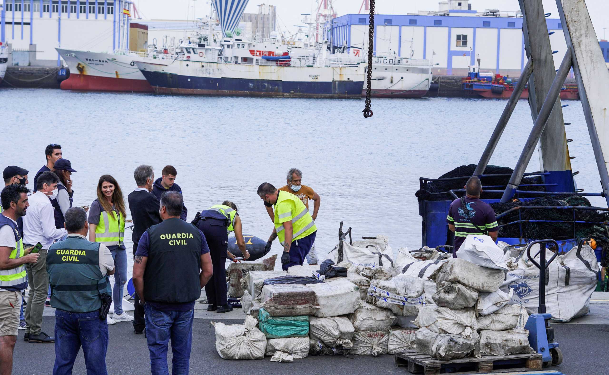 Police officers discharge drugs from the fishing boat "AKT-1" seized south of the Canary Islands in the port of Las Palmas, in the island of Gran Canaria, Spain, April 16, 2022. REUTERS