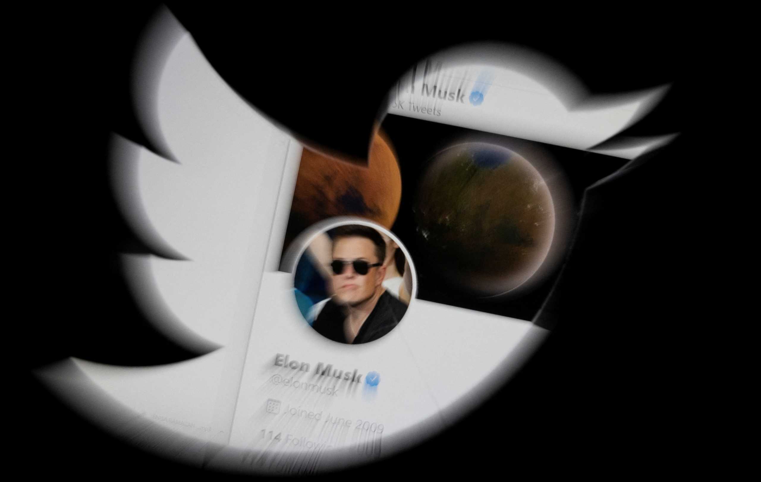 Elon Musk twitter account is seen through Twitter logo in this illustration taken, April 25, 2022. REUTERS