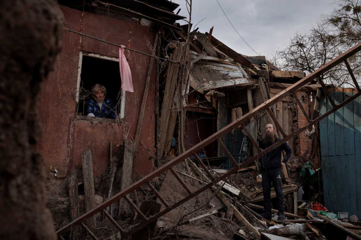 Lidiya Mezhiritska and her son Oleg Mezhiritsky assess the damage to their house after a rocket exploded outside, in a residential area in Kharkiv, as Russia's attack on Ukraine continues, Ukraine, April 8, 2022.  REUTERS