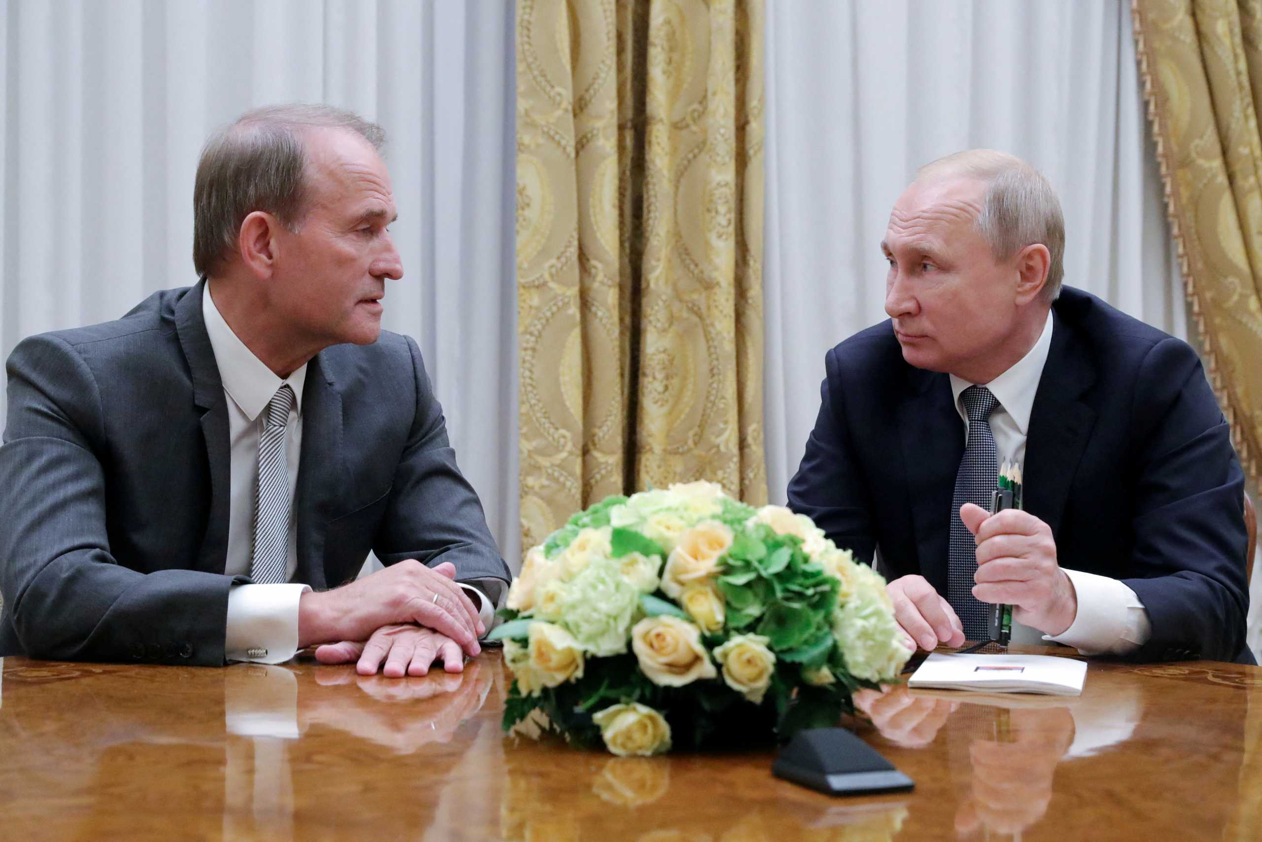 FILE PHOTO: Russia's President Vladimir Putin (R) attends a meeting with leader of Ukraine’s Opposition Platform - For Life party Viktor Medvedchuk in Saint Petersburg, Russia July 18, 2019. Sputnik