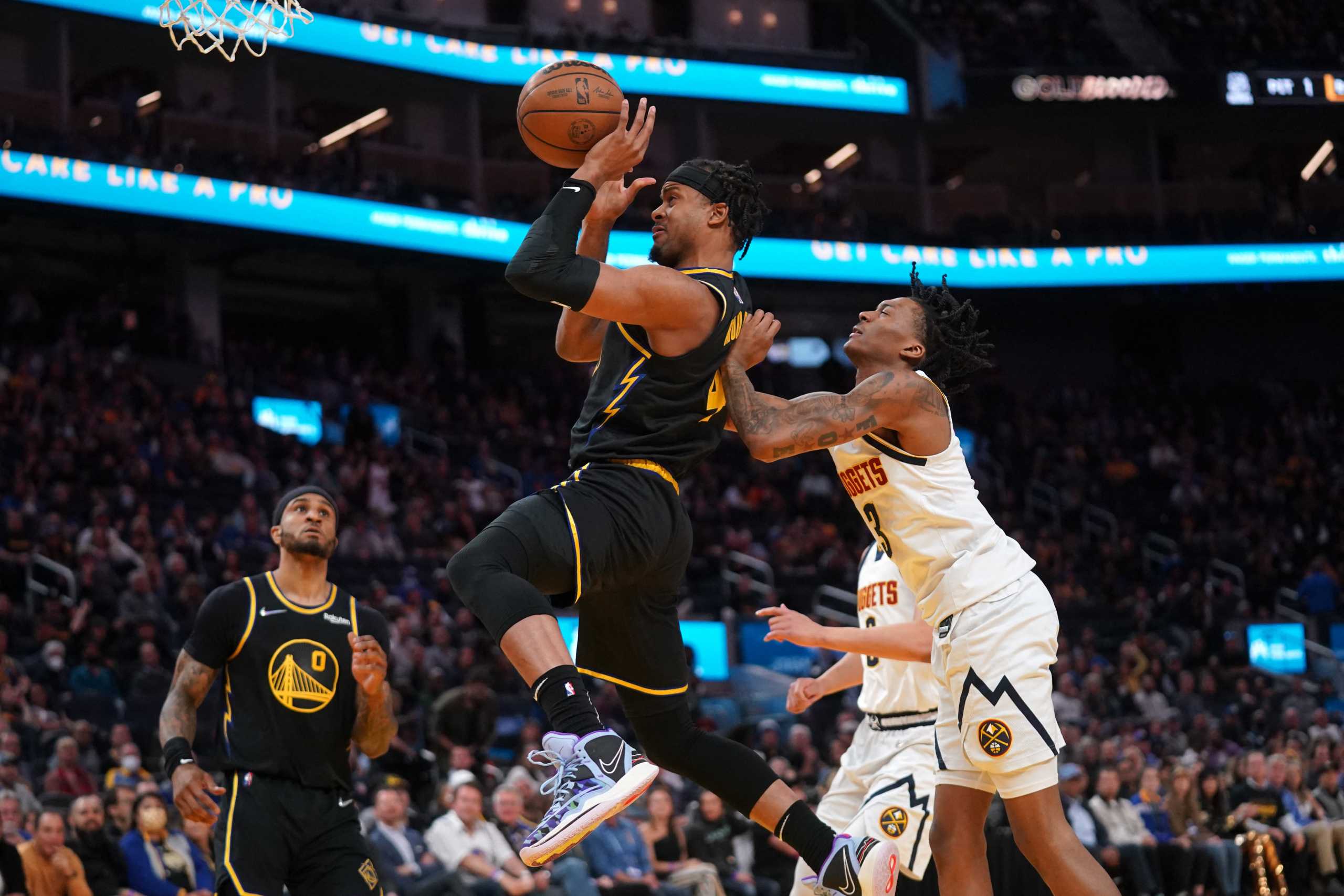 Apr 16, 2022; San Francisco, California, USA; Golden State Warriors guard Moses Moody (4) is fouled by Denver Nuggets guard Bones Hyland (3) in the fourth quarter during game one of the first round for the 2022 NBA playoffs at the Chase Center. Mandatory Credit: Cary Edmondson-USA TODAY Sports