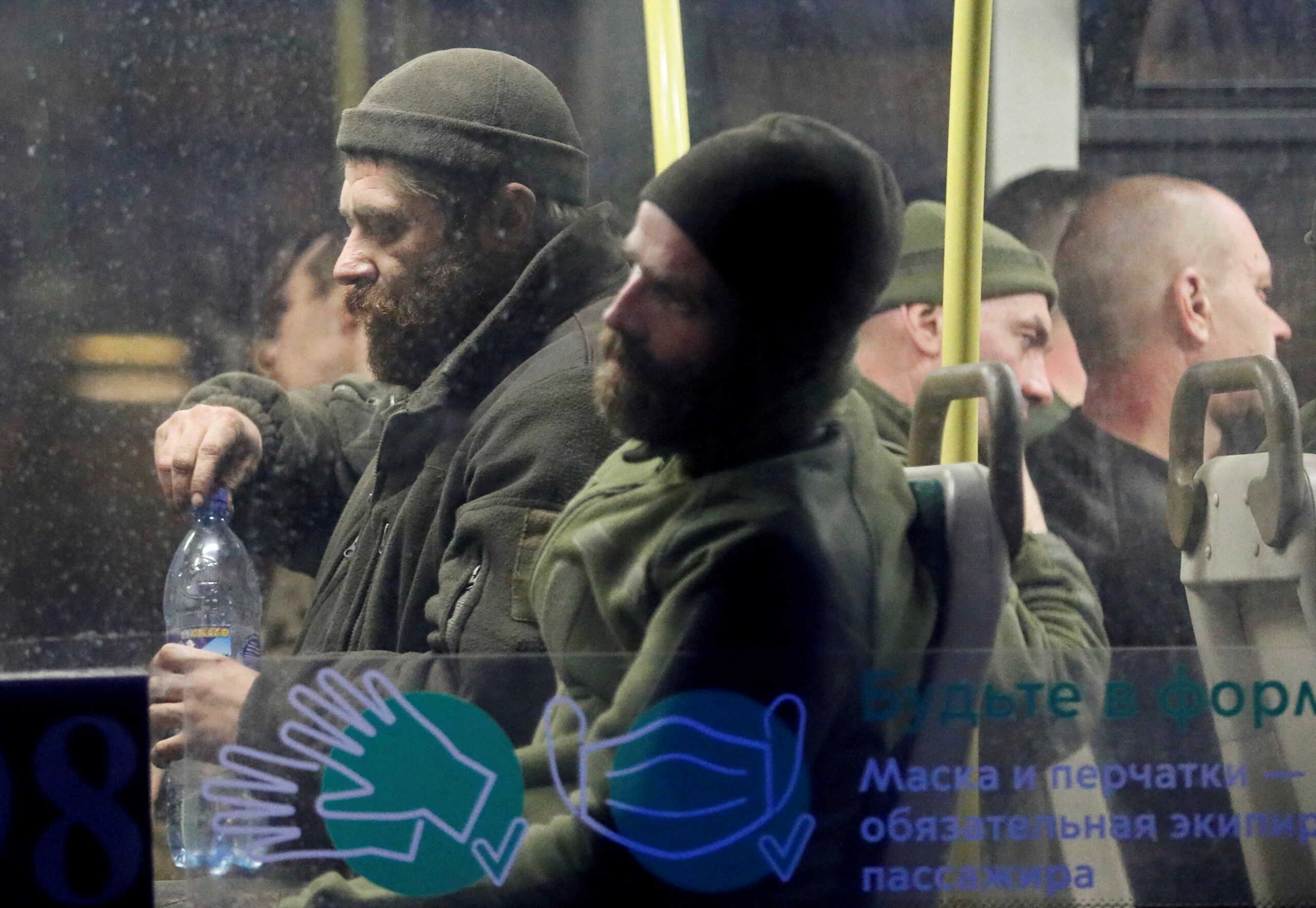 FILE PHOTO: Service members of Ukrainian forces who have surrendered after weeks holed up at Azovstal steel works are seen inside a bus, which arrived under escort of the pro-Russian military at a detention facility in the course of Ukraine-Russia conflict in the settlement of Olenivka in the Donetsk Region, Ukraine May 17, 2022. REUTERS