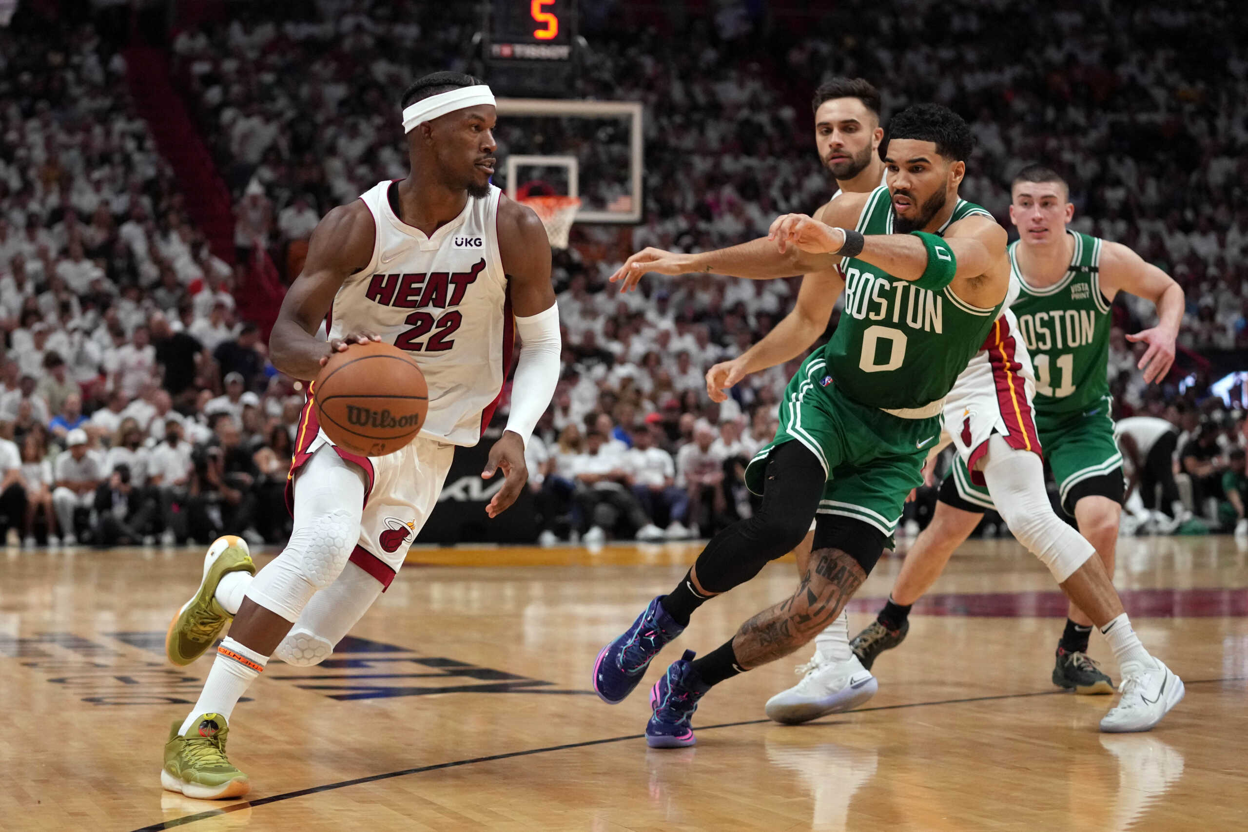 May 17, 2022; Miami, Florida, USA; Miami Heat forward Jimmy Butler (22) moves the ball up court against Boston Celtics forward Jayson Tatum (0) during the second half of game one of the 2022 eastern conference finals at FTX Arena. Mandatory Credit: Jasen Vinlove-USA TODAY Sports