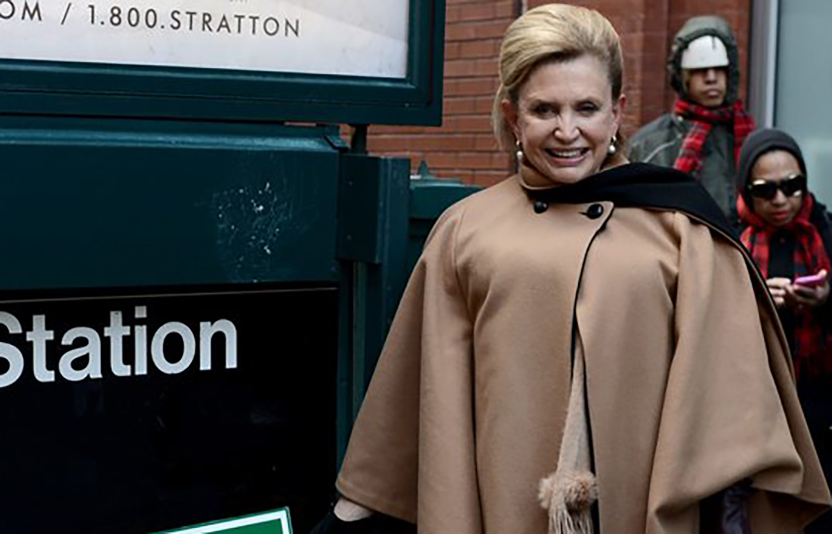 epa03568642 US Congresswoman Carolyn B. Maloney (Democrat - Manhattan, Queens, Brooklyn) stands next to a sign proposing a name change to the 77th Street subway station in honor of former New York City Mayor Edward in New York, New York, USA, 04 February 2013. Koch was a three term mayor of New York City who died last week at the age of 88  EPA