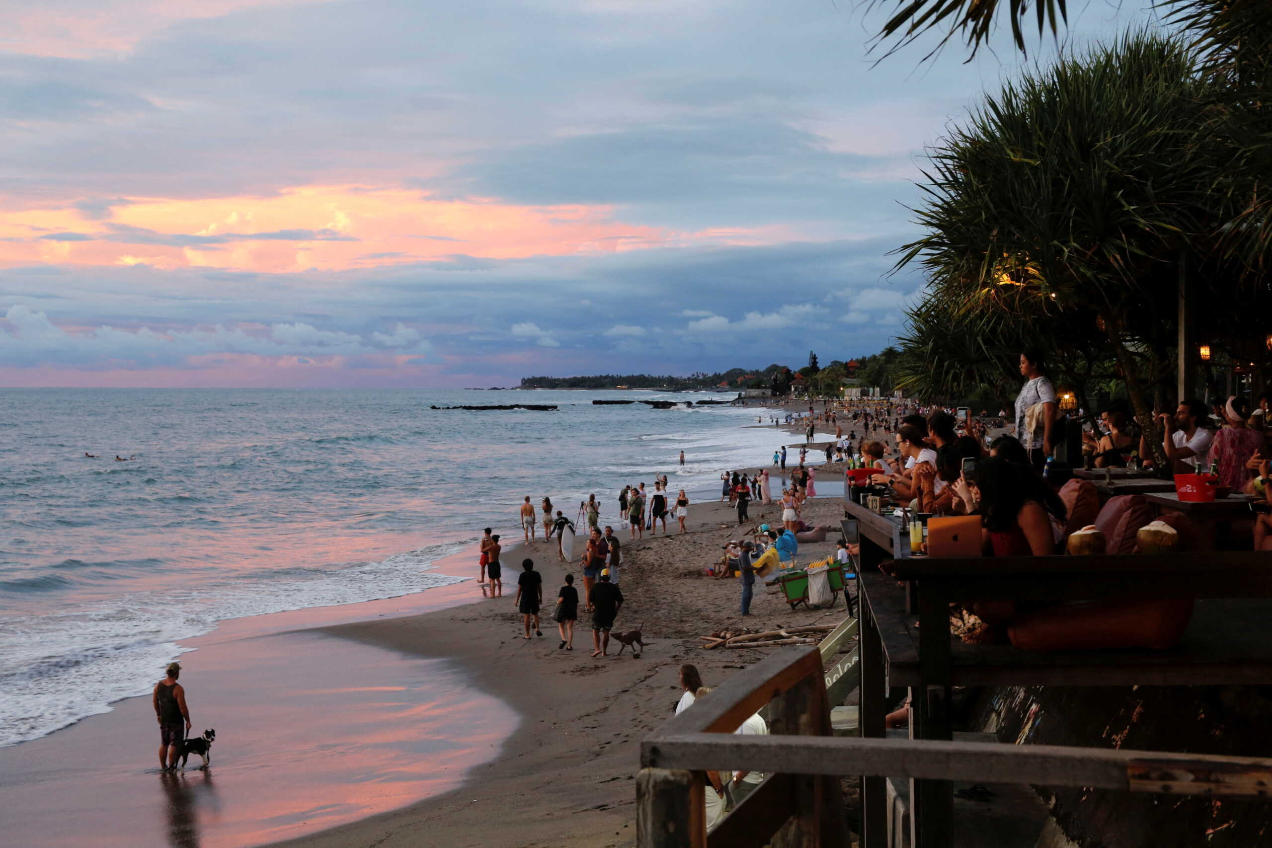 FILE PHOTO: Tourists enjoy the sunset at Canggu beach amidst the coronavirus disease (COVID-19) pandemic in Bali, Indonesia, December 2, 2021. REUTERS
