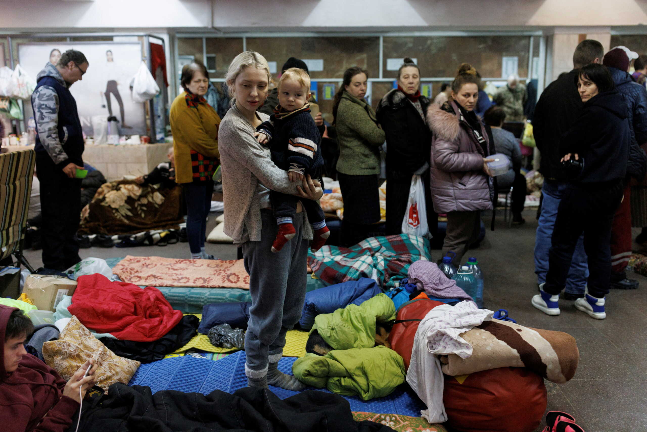 FILE PHOTO: Katarina Bovt holds son son Nikita in a metro station in northern Kharkiv where they live to shelter from shelling in their neighbourhood as Russia's attack on Ukraine continues, Ukraine, March 24, 2022. Bovt has moved to the underground shelter three weeks ago. REUTERS