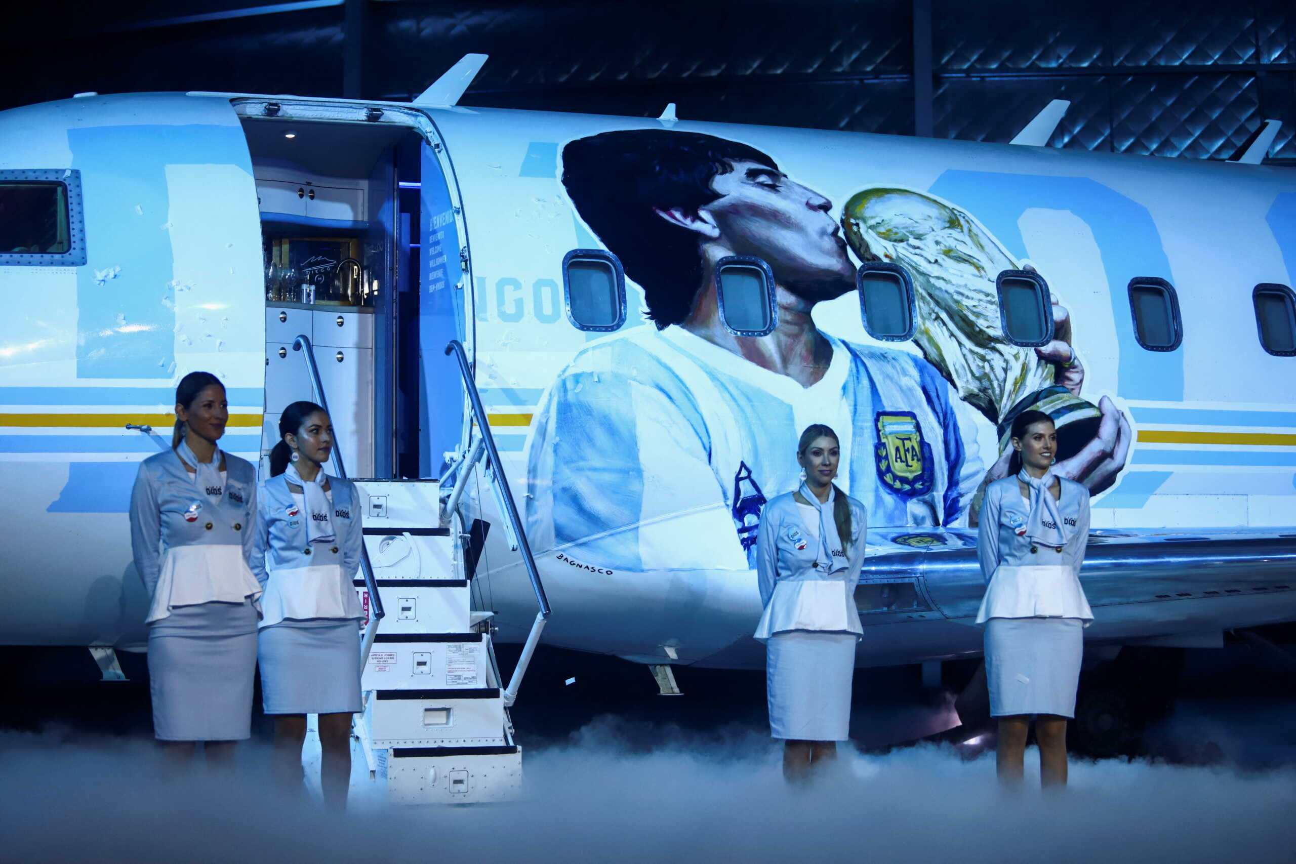 People take part in an event to launch the world tour to Qatar’s World Cup of the TANGO D10S, a themed airplane with a museum with objects used by late soccer legend Diego Armando Maradona, in Buenos Aires, Argentina May 25, 2022. REUTERS