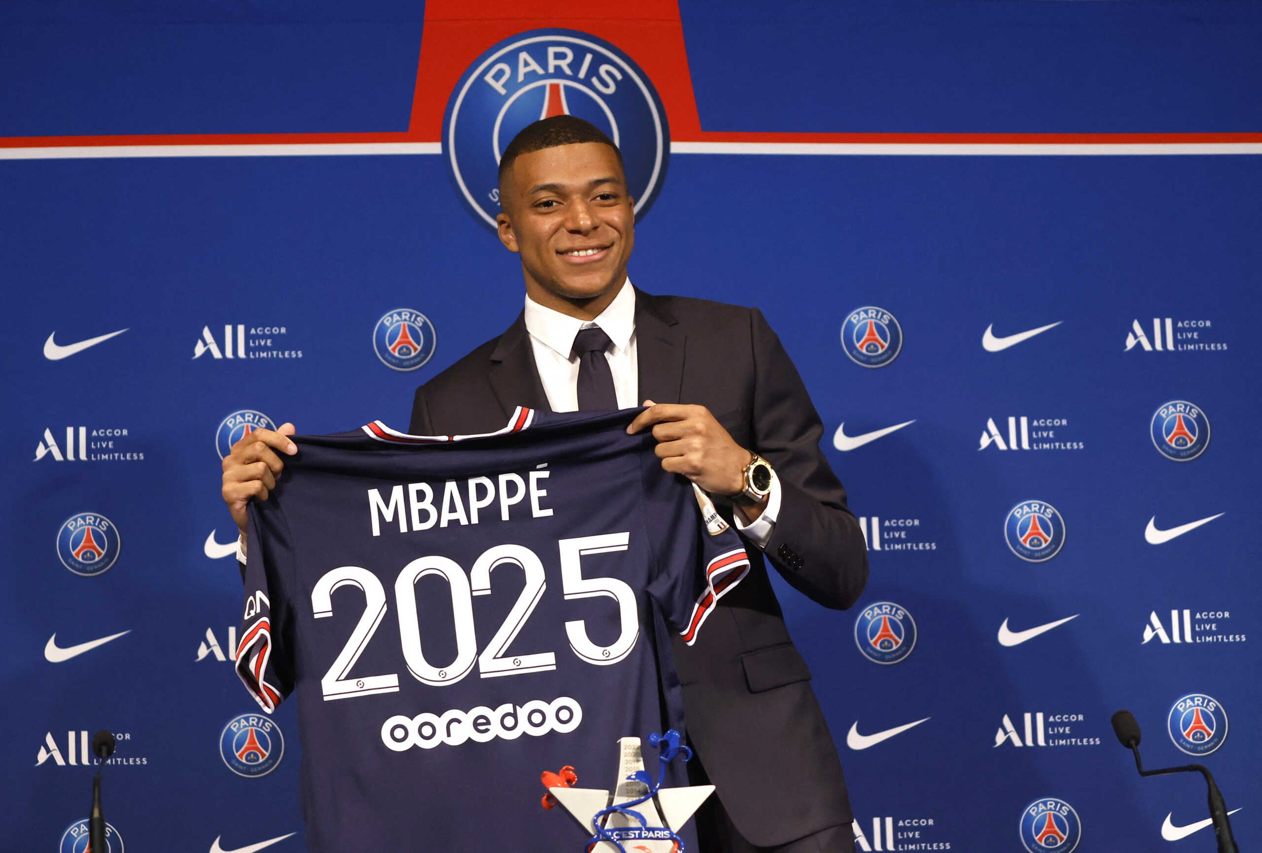 Soccer Football - Paris St Germain Press Conference - Paris, France - May 23, 2022 Paris St Germain's Kylian Mbappe poses holding a shirt during the press conference REUTERS