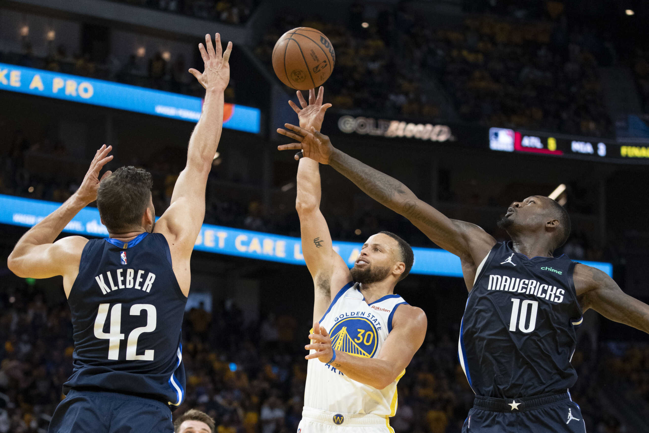 May 20, 2022; San Francisco, California, USA; Golden State Warriors guard Stephen Curry (30) shoots the basketball against Dallas Mavericks forward Maxi Kleber (42) and forward Dorian Finney-Smith (10) during the third quarter in game two of the 2022 western conference finals at Chase Center. Mandatory Credit: Kyle Terada-USA TODAY Sports