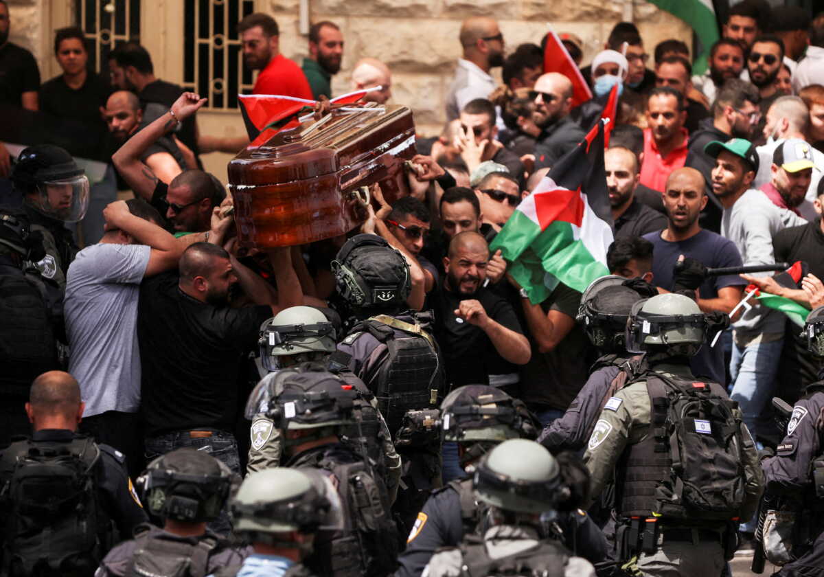 Family and friends carry the coffin of Al Jazeera reporter Shireen Abu Akleh, who was killed during an Israeli raid in Jenin in the occupied West Bank, as clashes erupted with Israeli security forces, during her funeral in Jerusalem, May 13, 2022. REUTERS