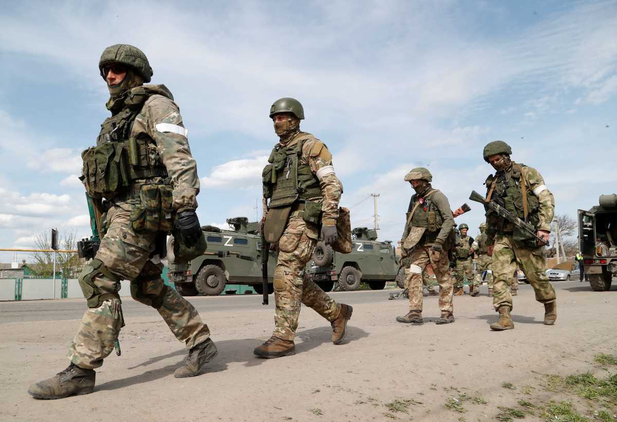 Service members of pro-Russian troops walk near a temporary accommodation centre for evacuees during Ukraine-Russia conflict in the village of Bezimenne in the Donetsk Region, Ukraine May 1, 2022. REUTERS