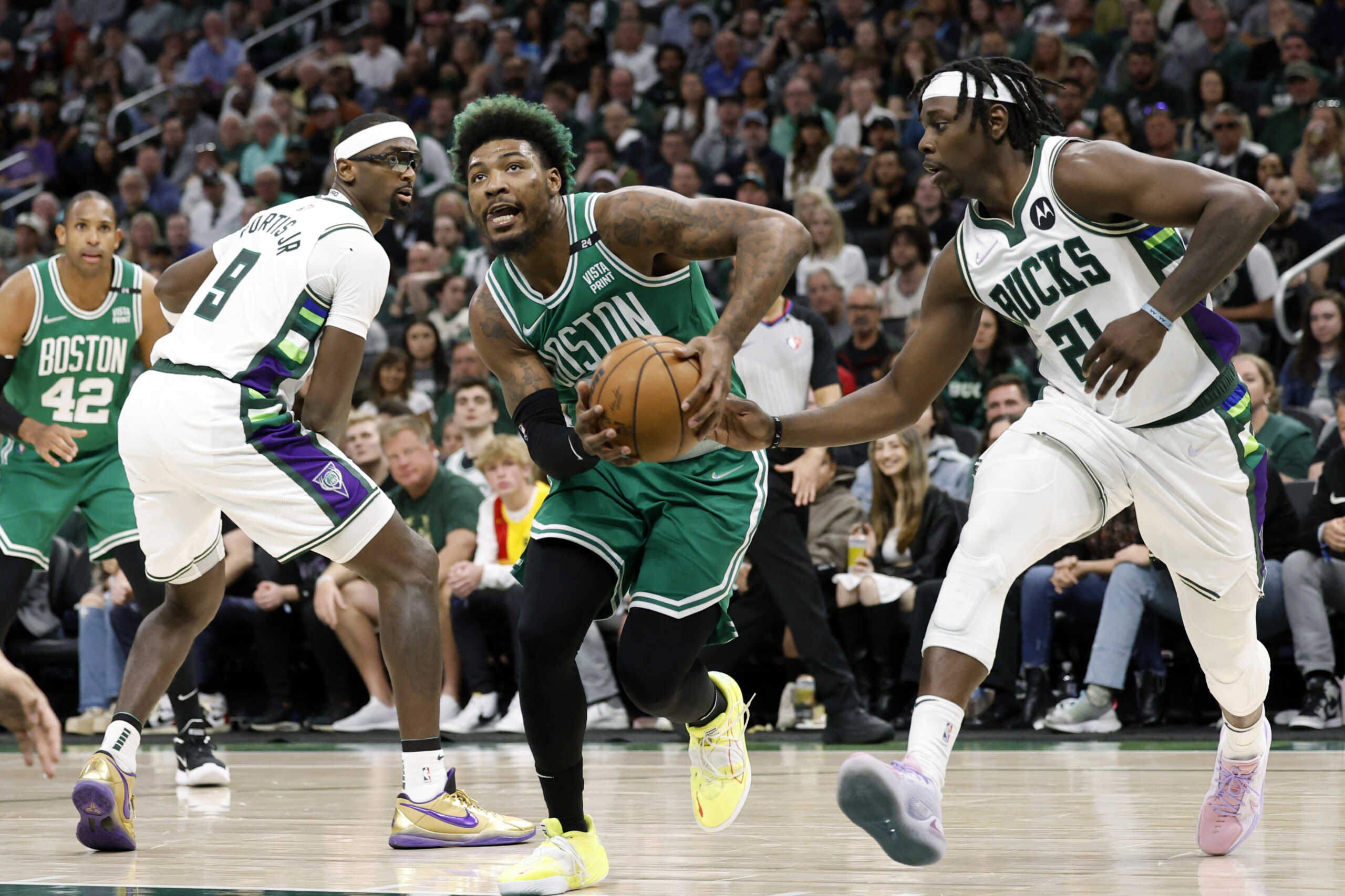 May 7, 2022; Milwaukee, Wisconsin, USA; Boston Celtics guard Marcus Smart (36) drives for the basket against Milwaukee Bucks guard Jrue Holiday (21) during the fourth quarter during game three of the second round for the 2022 NBA playoffs at Fiserv Forum. Mandatory Credit: Jeff Hanisch-USA TODAY Sports