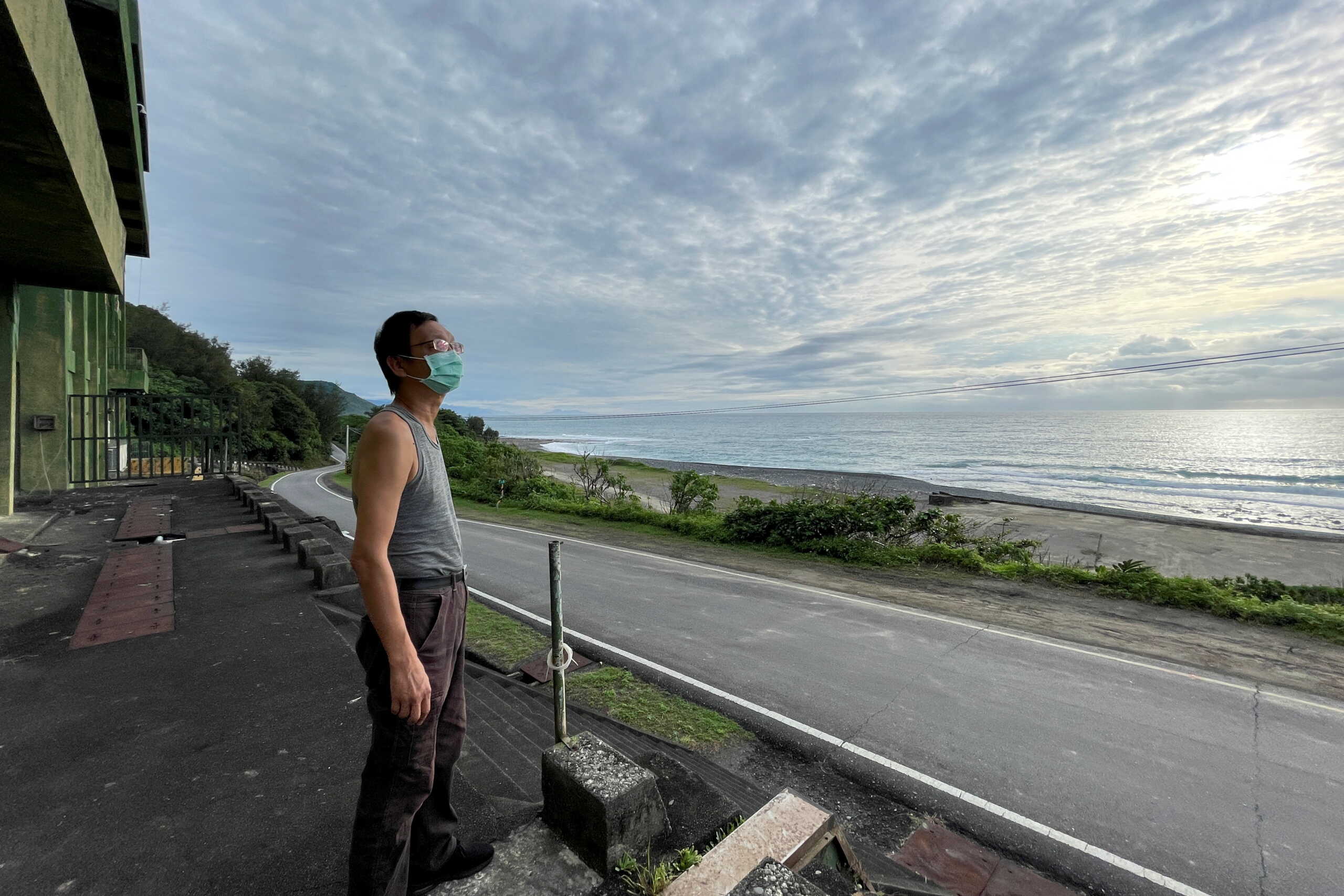 Radio enthusiast Robin Hsu, 50, looks into the sky while standing at an unused military facility in Pingtung, Taiwan May 5, 2022. Picture taken May 5, 2022. REUTERS