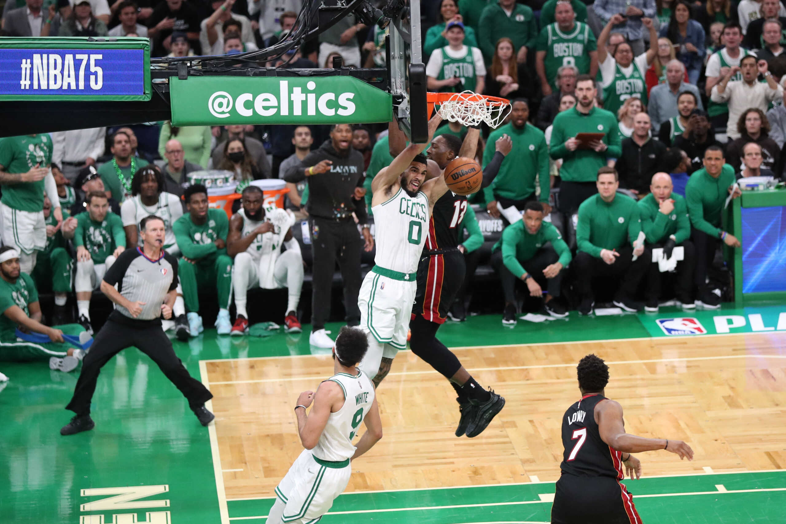 May 23, 2022; Boston, Massachusetts, USA; Boston Celtics forward Jayson Tatum (0) hangs from the basket in the first quarter against the Miami Heat during game four of the 2022 eastern conference finals at TD Garden. Mandatory Credit: Paul Rutherford-USA TODAY Sports