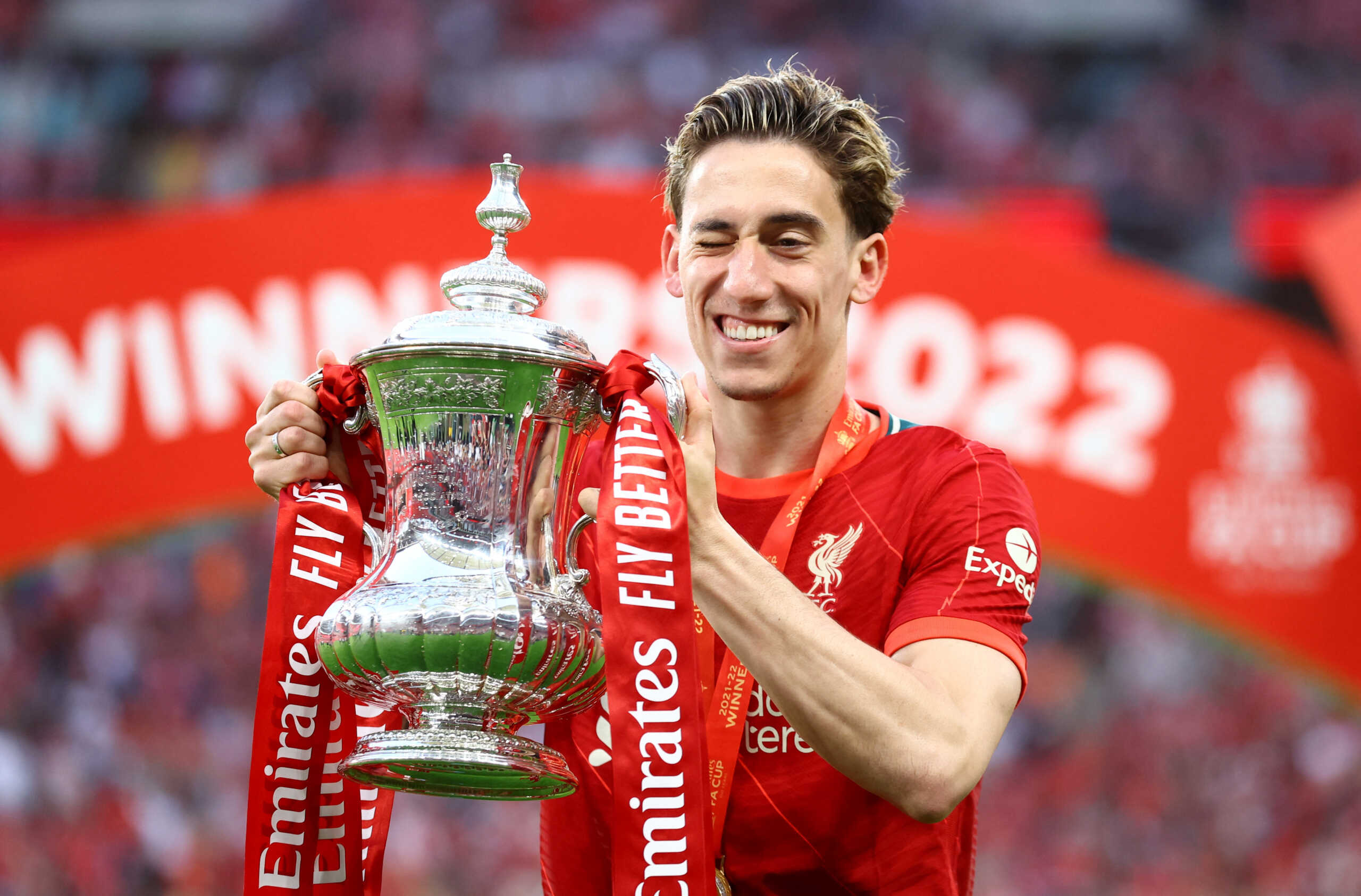Soccer Football - FA Cup - Final - Chelsea v Liverpool - Wembley Stadium, London, Britain - May 14, 2022 Liverpool's Kostas Tsimikas celebrates with the trophy after winning the FA Cup final REUTERS