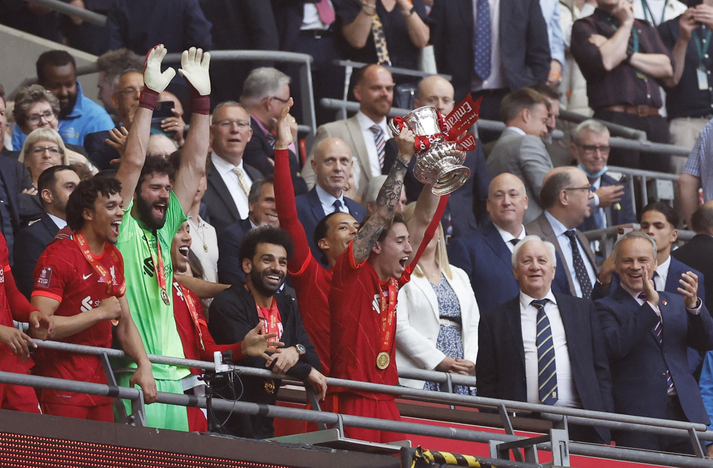 Soccer Football - FA Cup - Final - Chelsea v Liverpool - Wembley Stadium, London, Britain - May 14, 2022 Liverpool's Kostas Tsimikas lifts the trophy with teammates after winning the FA Cup final Action Images via Reuters