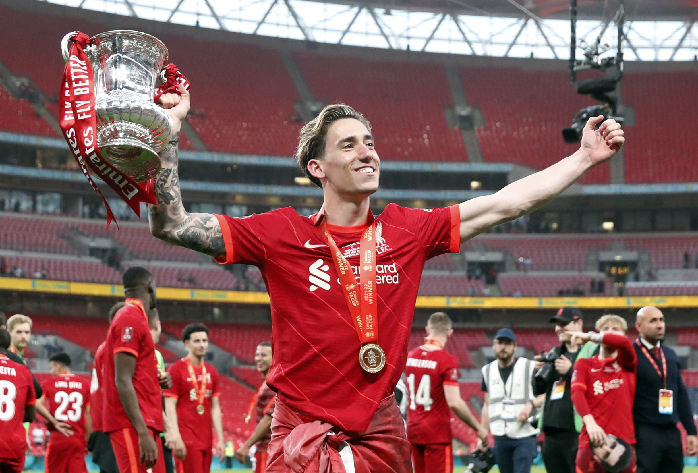 Soccer Football - FA Cup - Final - Chelsea v Liverpool - Wembley Stadium, London, Britain - May 14, 2022 Liverpool's Kostas Tsimikas lifts the trophy after winning the FA Cup final Action Images via Reuters