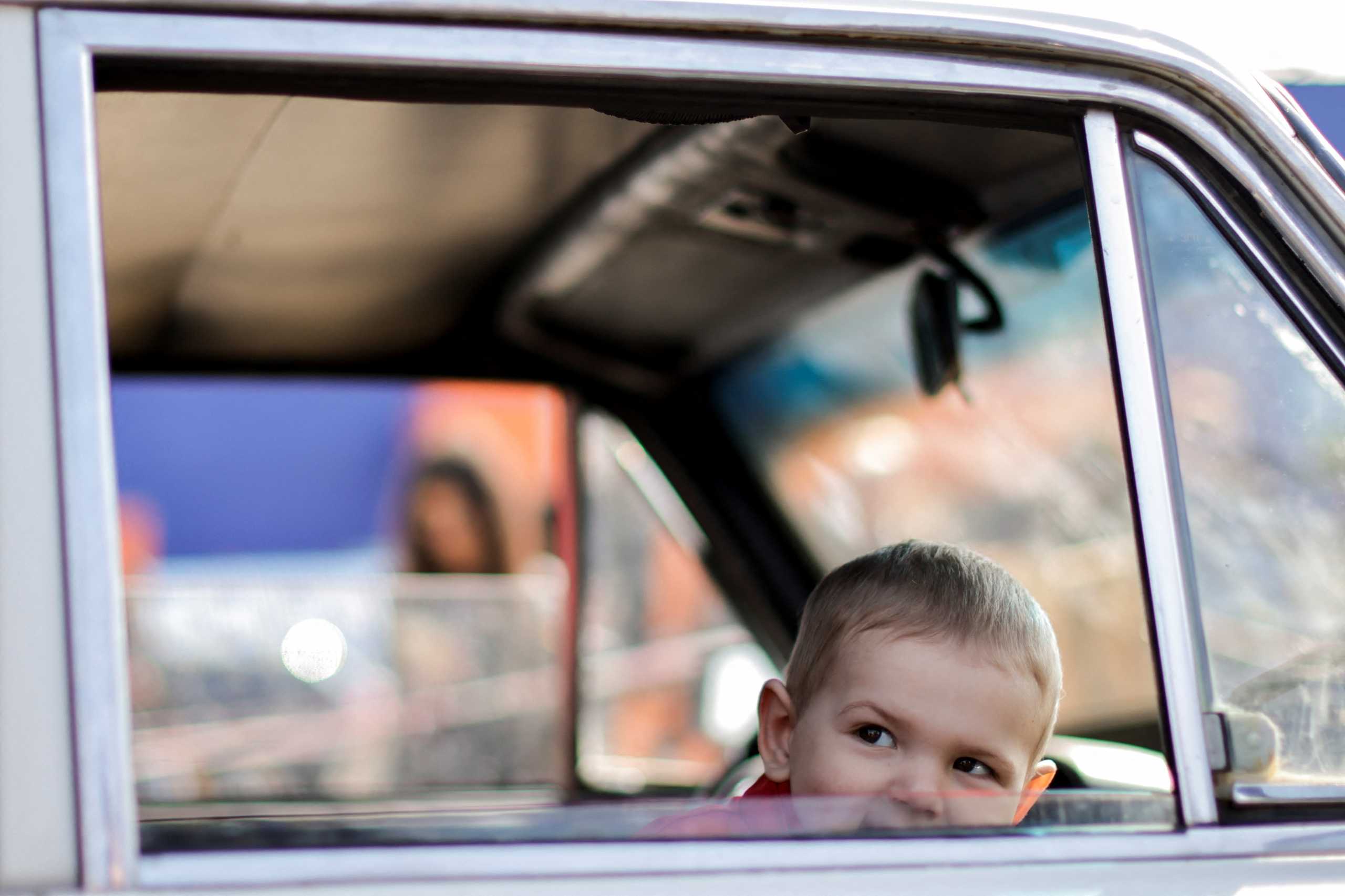 A Ukrainian boy refugee from Mariupol area, looks out of a vehicle's window after arriving at a registration centre for internally displaced people, amid Russia's ongoing invasion of Ukraine, in Zaporizhzhia, Ukraine May 2, 2022. REUTERS